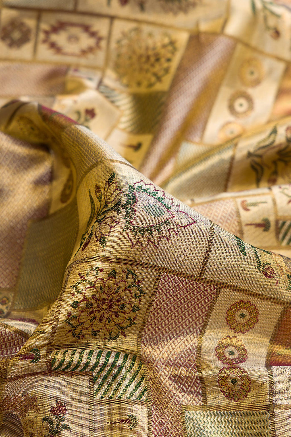Close up of Gold Dual Tone Kanjivaram Tissue Saree with Zari Brocade on the body and Fancy Border.  displaying folds