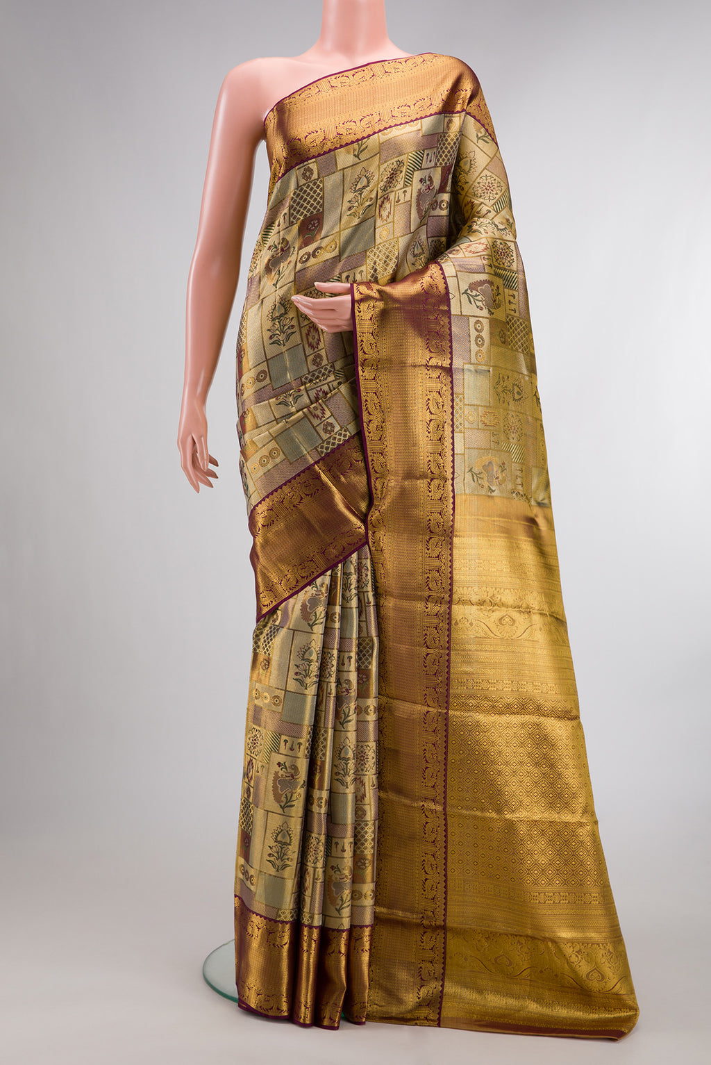 Gold Dual Tone Kanjivaram Tissue Saree with Zari Brocade on the body and Fancy Border.  displayed on a mannequin