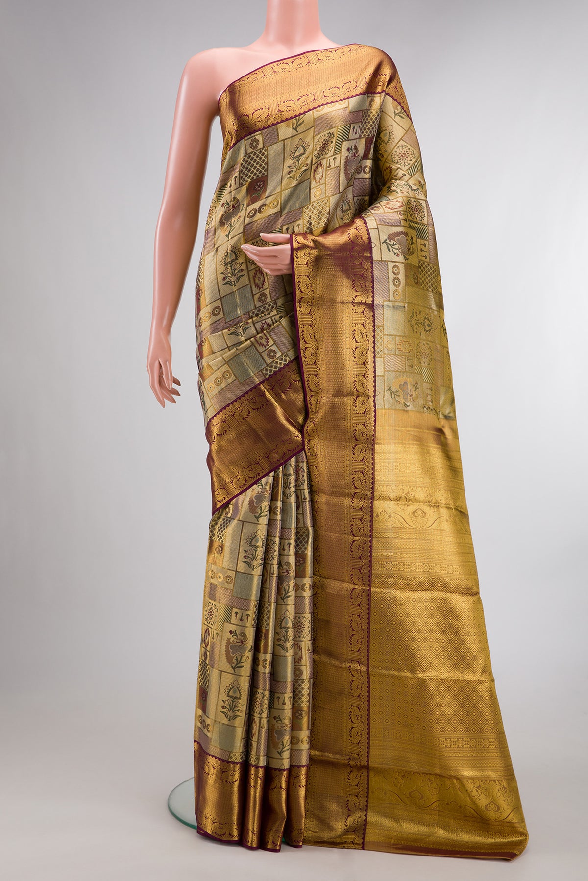 Gold Dual Tone Kanjivaram Tissue Saree with Zari Brocade on the body and Fancy Border.  displayed on a mannequin