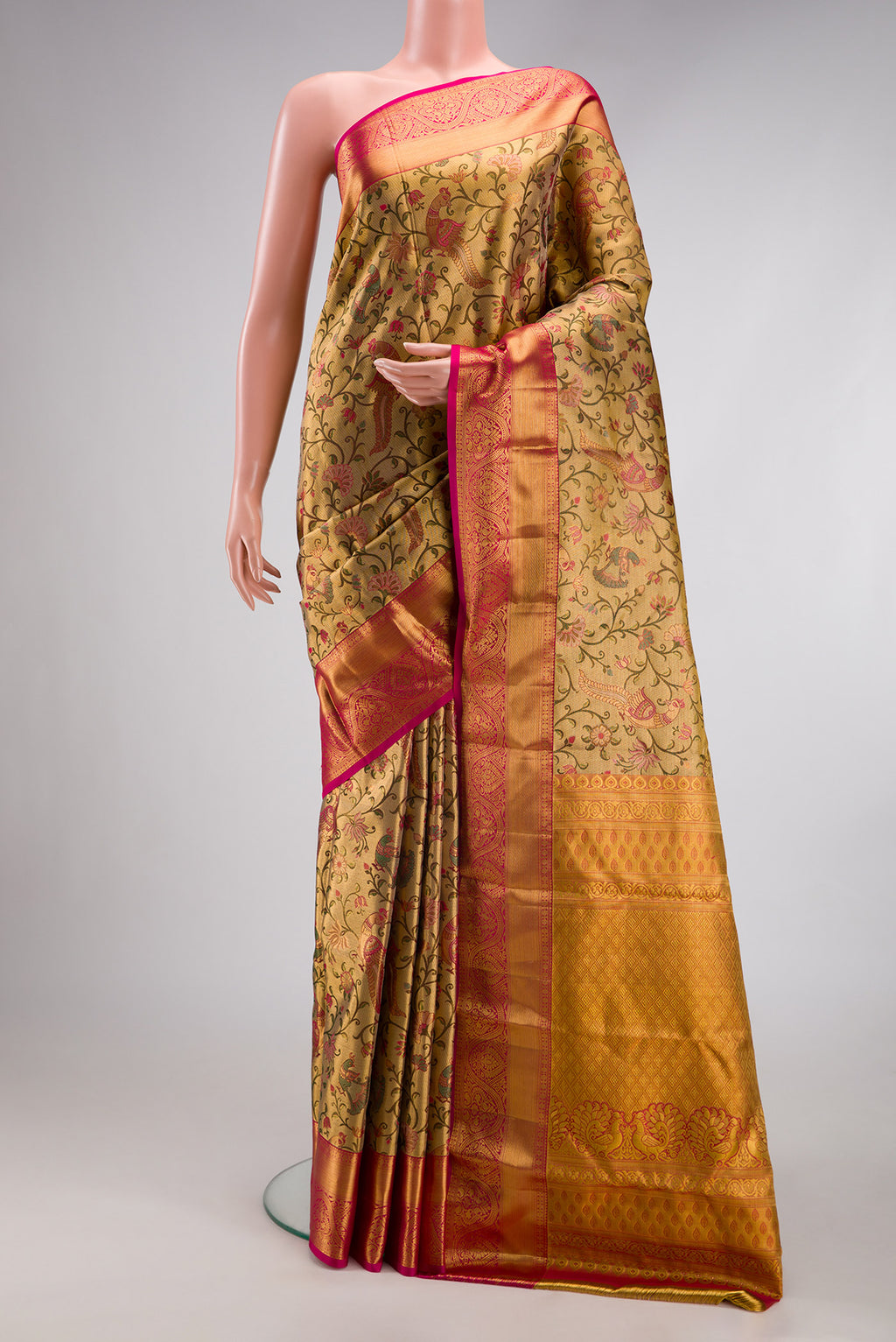 Gold Dual Tone Kanjivaram Tissue Silk Saree with Zari Brocade on the body and Fancy Border.  displayed on a mannequin