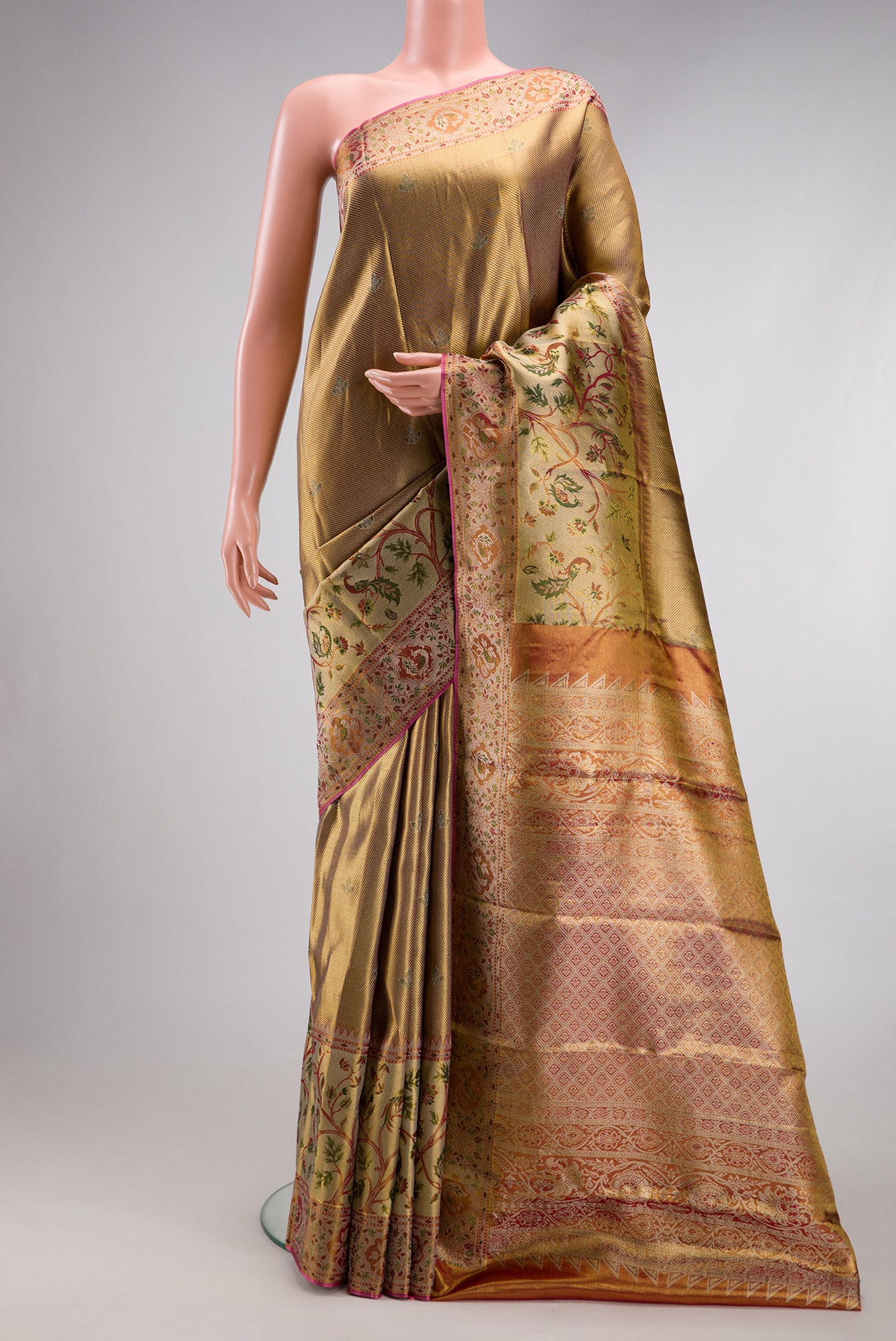 Gold Dual Tone Kanjivaram Tissue Silk Saree with Zari Brocade on the body and Fancy Border.  displayed on a mannequin