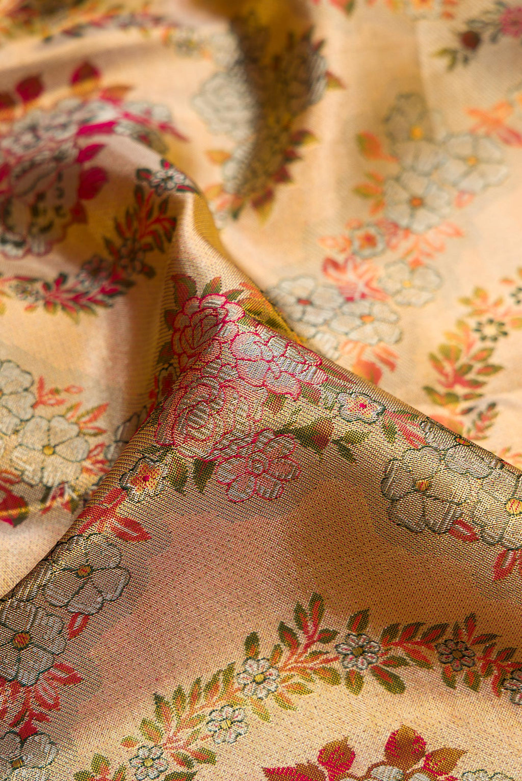 Close up of Gold Dual Tone Kanjivaram Tissue Silk Saree with Zari Brocade on the body and Fancy Border.  displaying folds