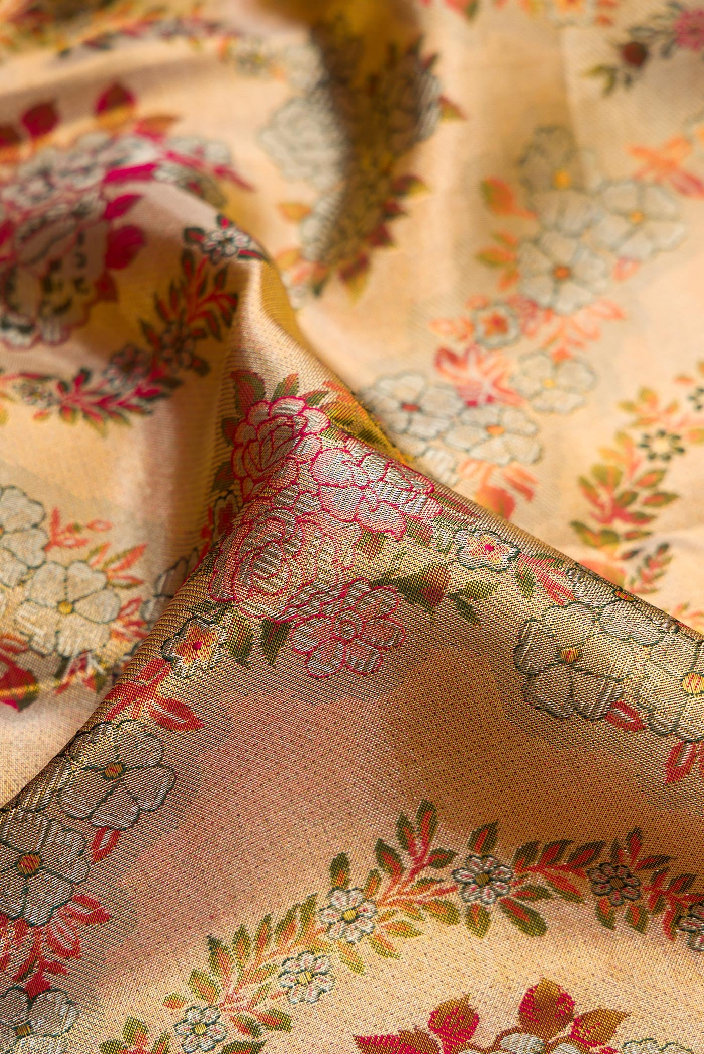 Close up of Gold Dual Tone Kanjivaram Tissue Silk Saree with Zari Brocade on the body and Fancy Border.  displaying folds