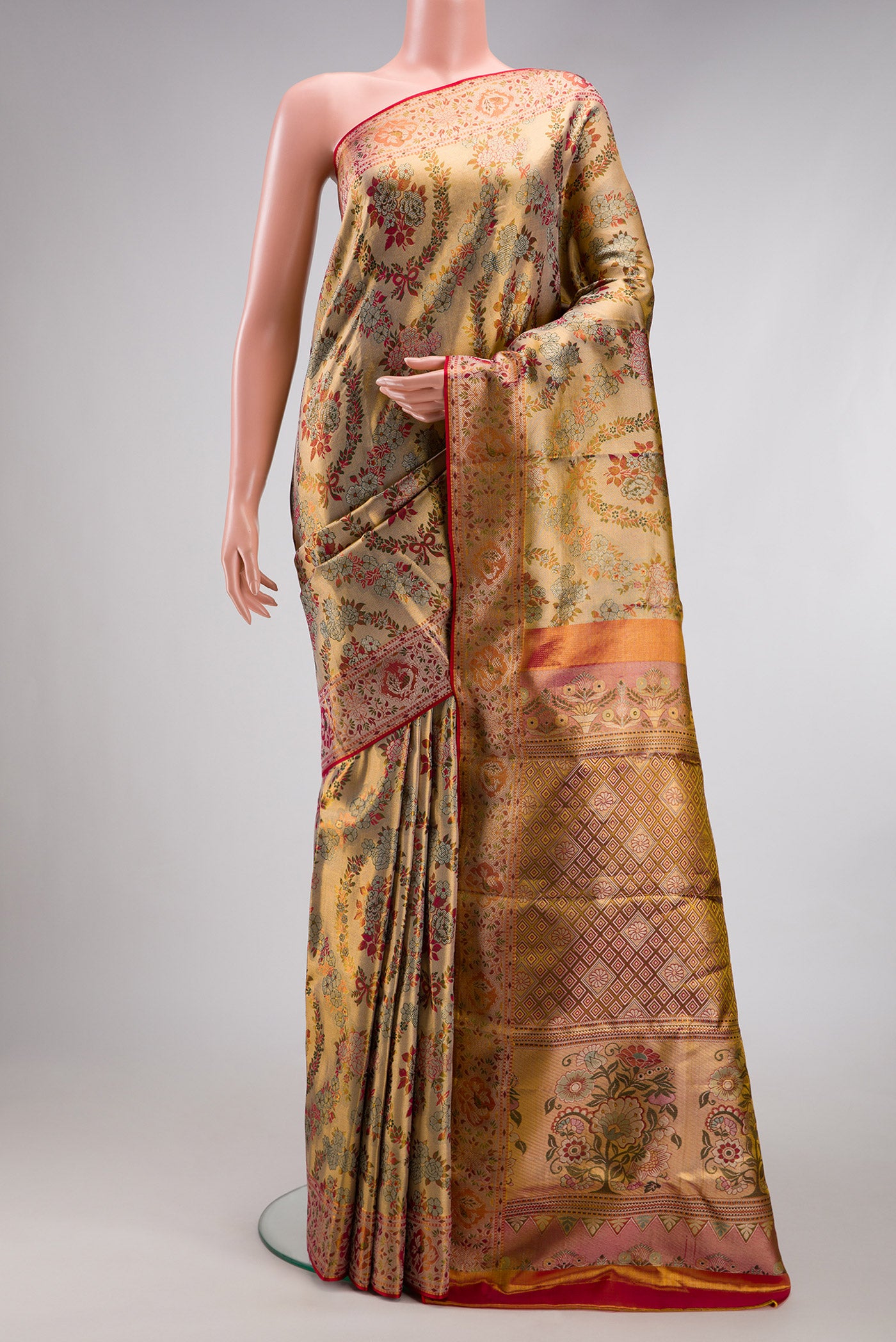 Gold Dual Tone Kanjivaram Tissue Silk Saree with Zari Brocade on the body and Fancy Border.  displayed on a mannequin