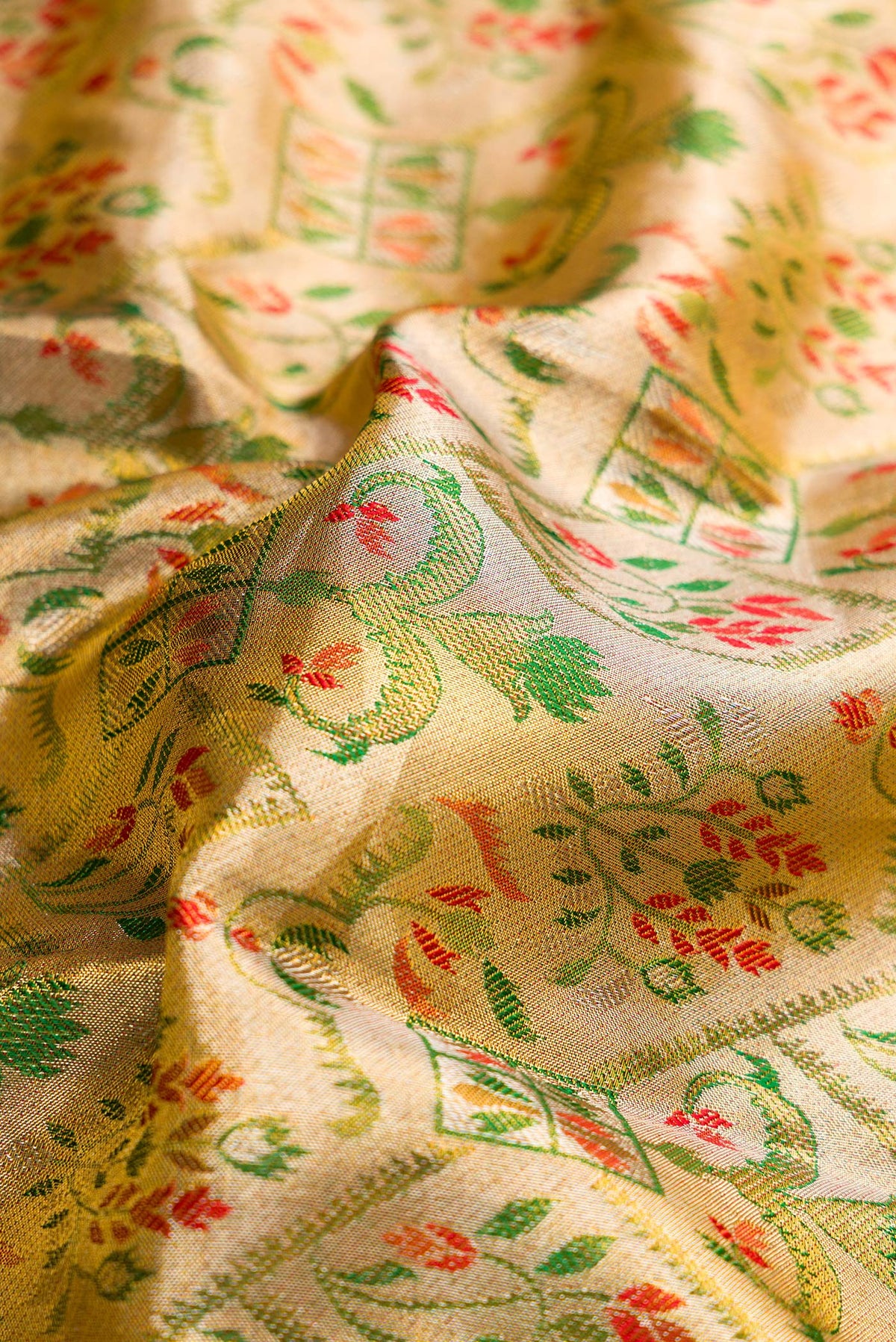 Close up of Gold Dual Tone Kanjivaram Tissue Saree with Zari Brocade on the body and Fancy Border.  displaying folds