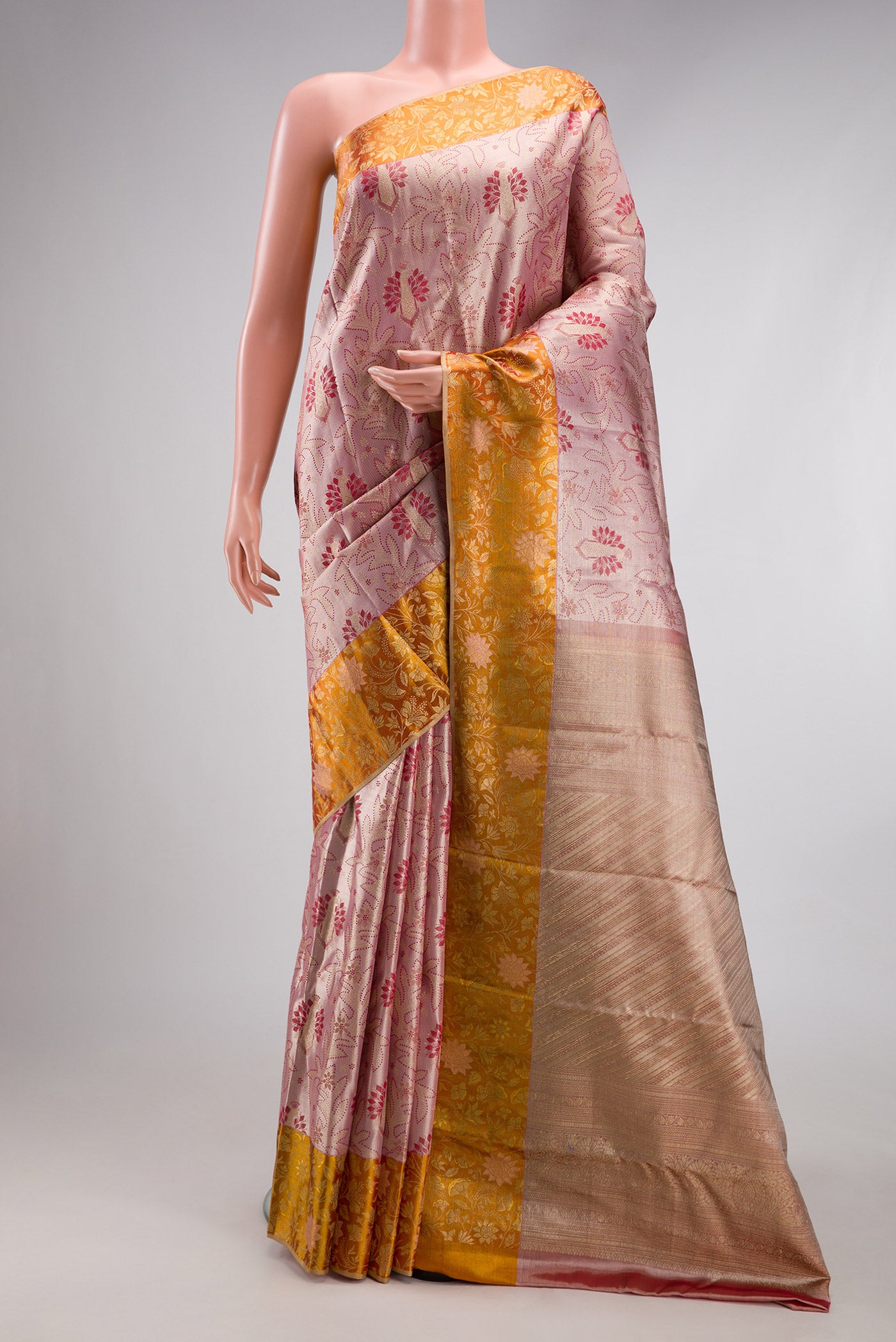 Rose Gold Dual Tone Kanjivaram Tissue Silk Saree with Zari Brocade on the body and Fancy Border.  displayed on a mannequin