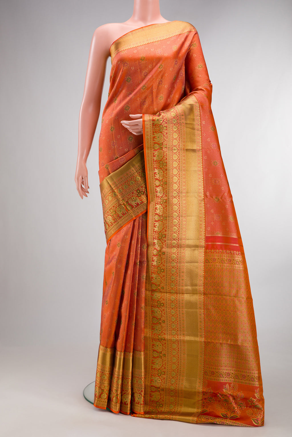 Pure Silk Orange Kanjivaram Saree with Zari Brocade on the body and Fancy Border.  displayed on a mannequin
