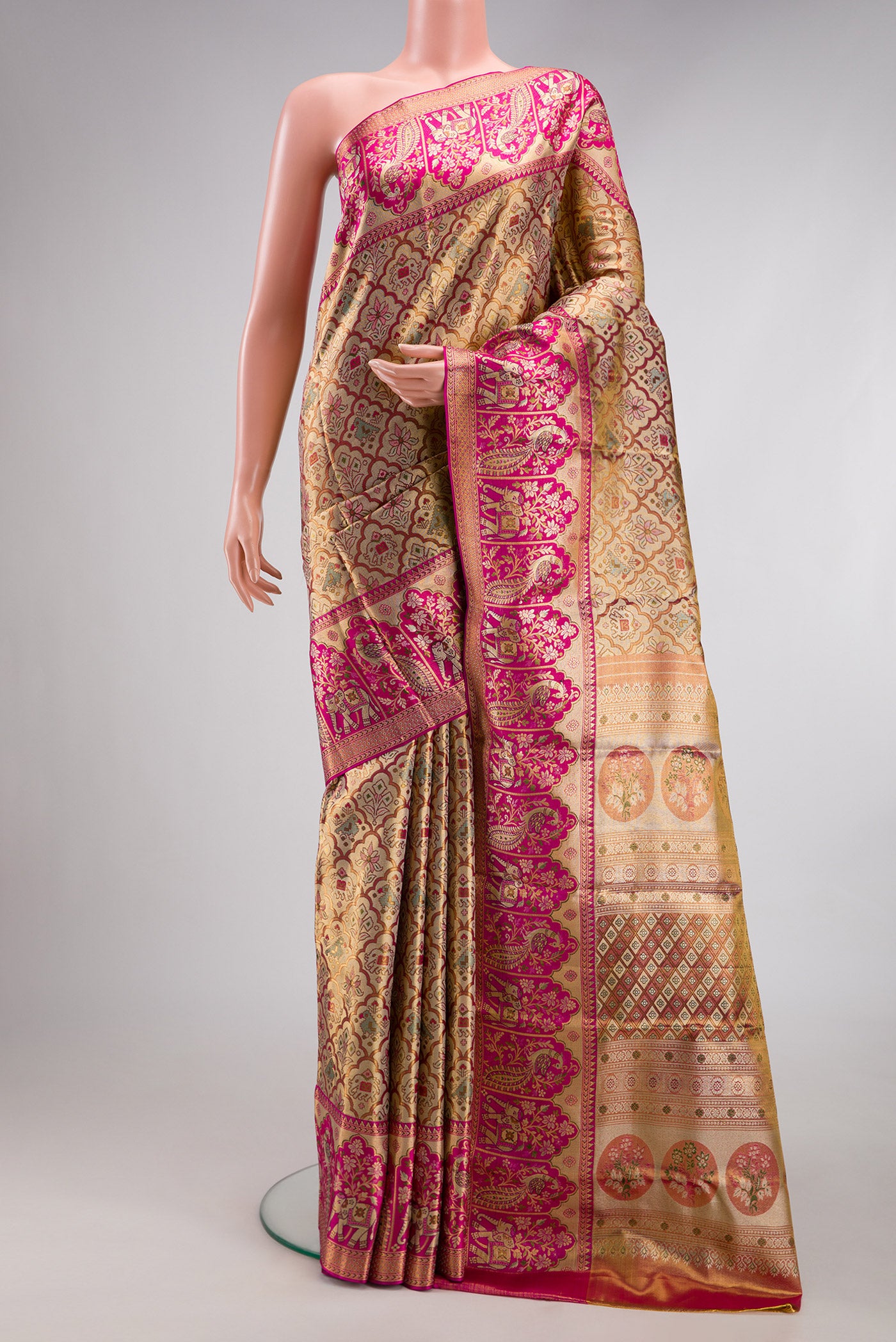 Gold Dual Tone Kanjivaram Tissue Silk Saree with Zari Brocade on the body and Fancy Border.  displayed on a mannequin