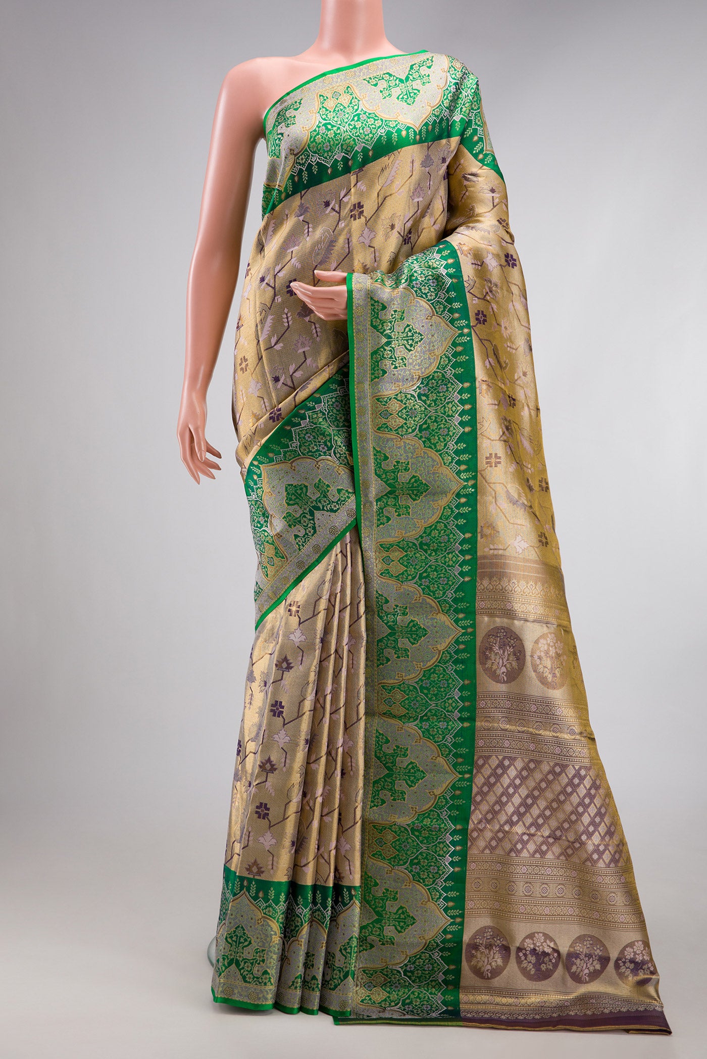 Gold Dual Tone Kanjivaram Tissue Silk Saree with Zari Brocade on the body and Fancy Border.  displayed on a mannequin