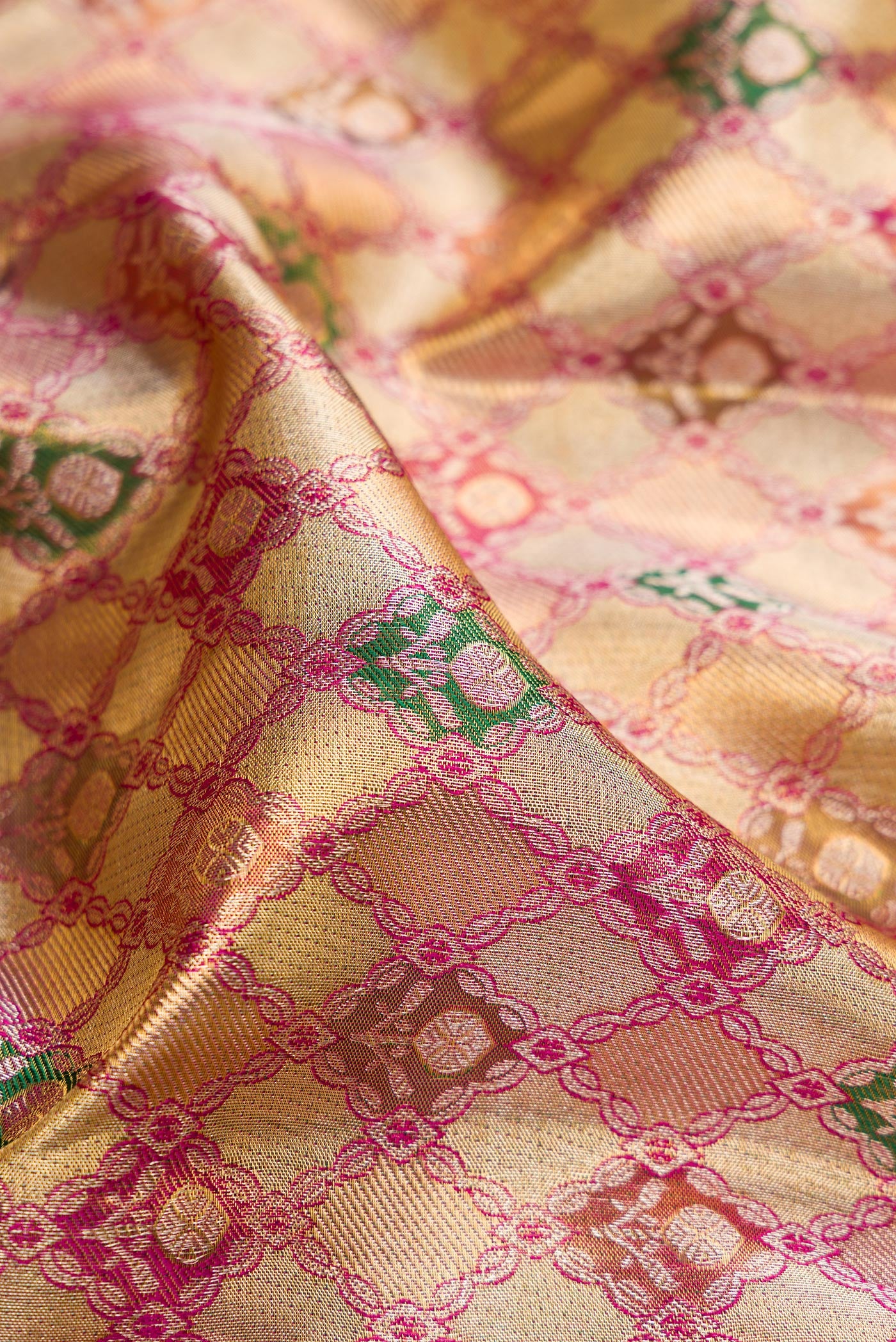 Close up of Gold Dual Tone Kanjivaram Tissue Silk Saree with Zari Brocade on the body and Fancy Border.  displaying folds