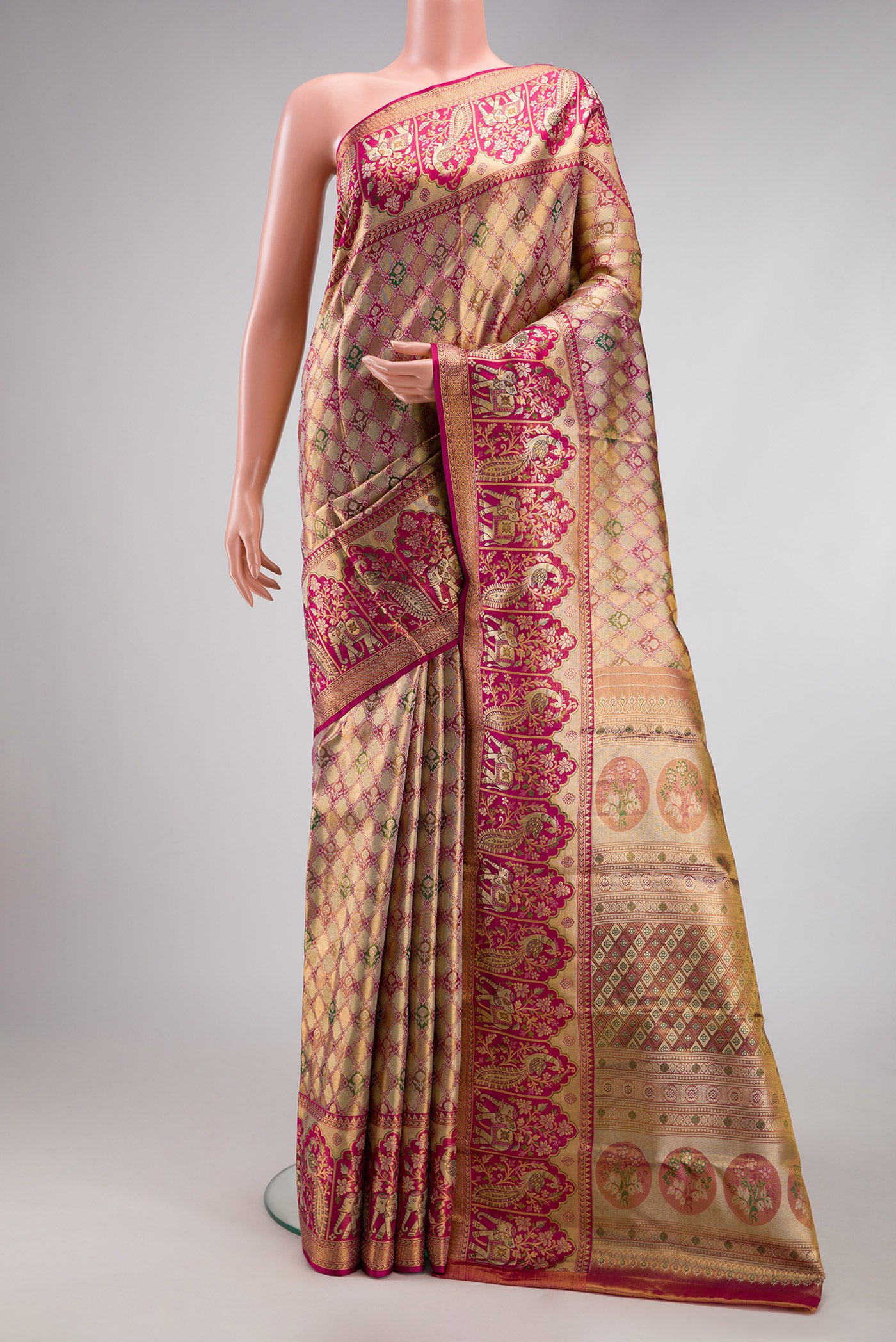 Gold Dual Tone Kanjivaram Tissue Silk Saree with Zari Brocade on the body and Fancy Border.  displayed on a mannequin