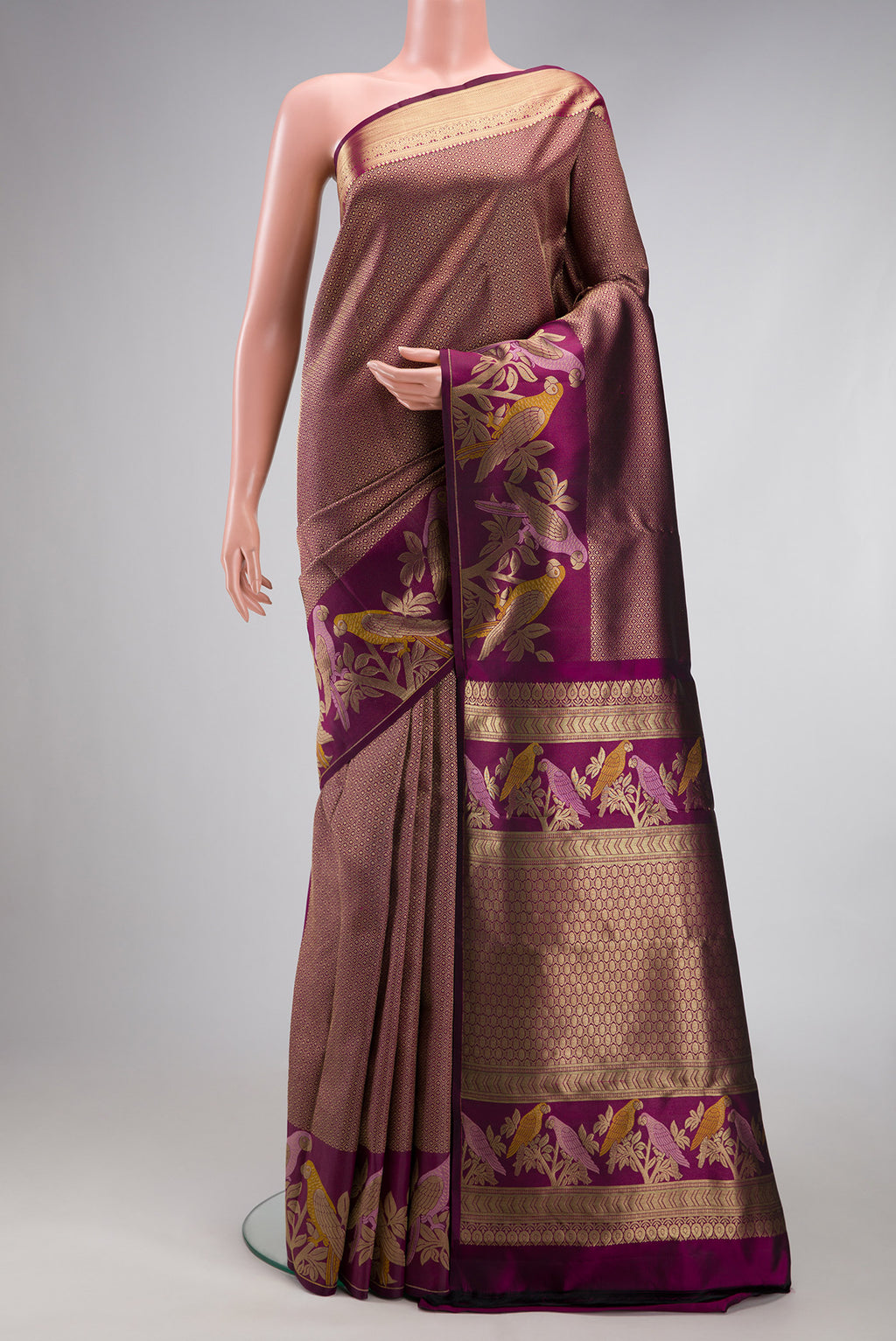 Purple Kanjivaram Silk Saree with Zari Brocade on the body and Fancy Border.  displayed on a mannequin