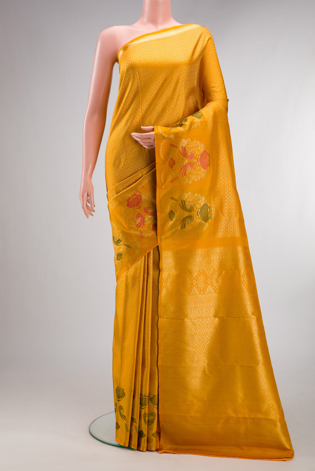 Pure Silk Mustard Kanjivaram Saree with Jacquard design on the body and Fancy Border.  displayed on a mannequin