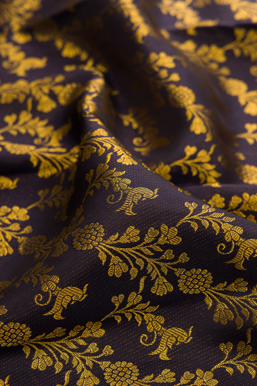 Close up of Pure Silk Navy Blue Dual Tone Kanjivaram Saree with Zari Brocade on the body and Zari Border.  displaying folds
