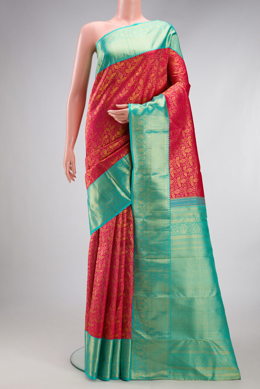 Dark Pink Kanjivaram Silk Saree with Zari Brocade on the body and Zari Border.  displayed on a mannequin