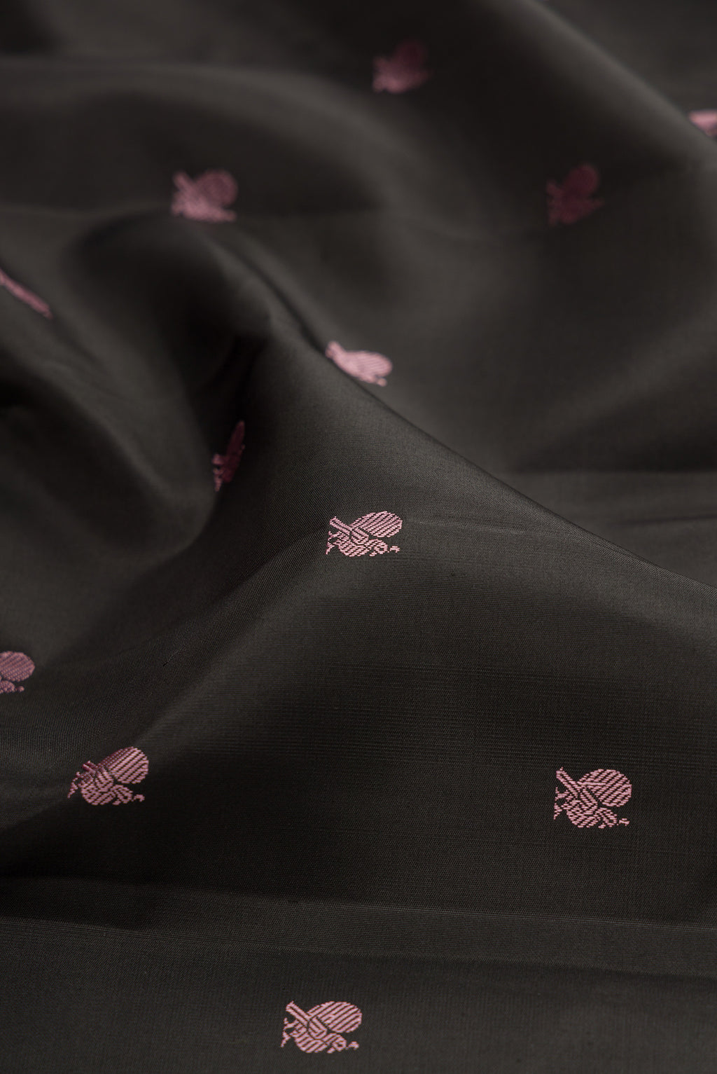 Close up of Black Kanchipuram Silk Saree with Thread Butta on the body and Thread Border.  displaying folds