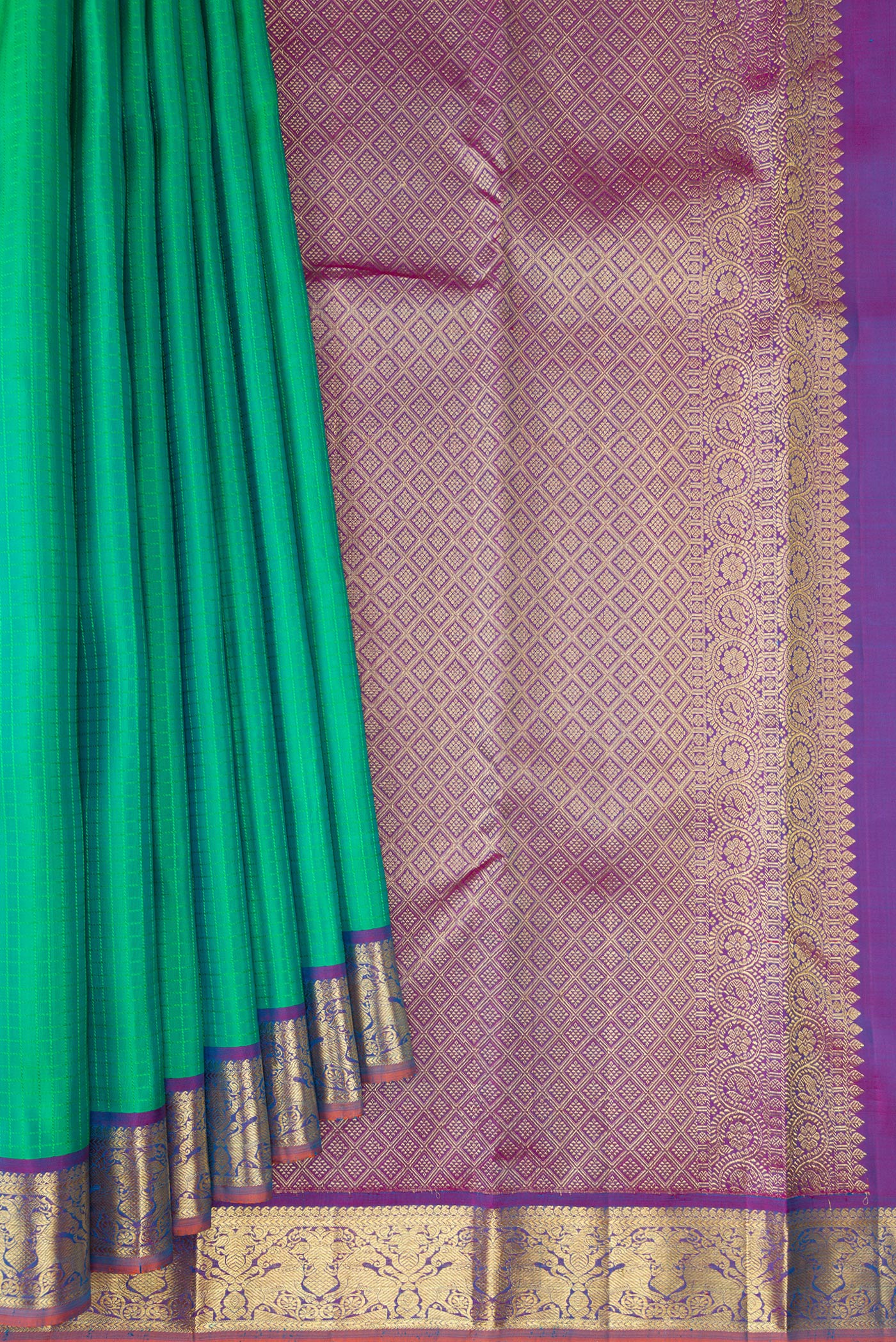 Pleats and pallu of Green Kanchipuram Silk Saree with Checked design on the body and Zari Border. 