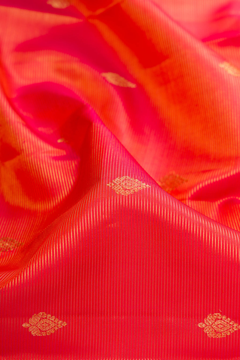 Close up of Orange Kanchipuram Silk Saree with Stripes on the body and Fancy Border.  displaying folds