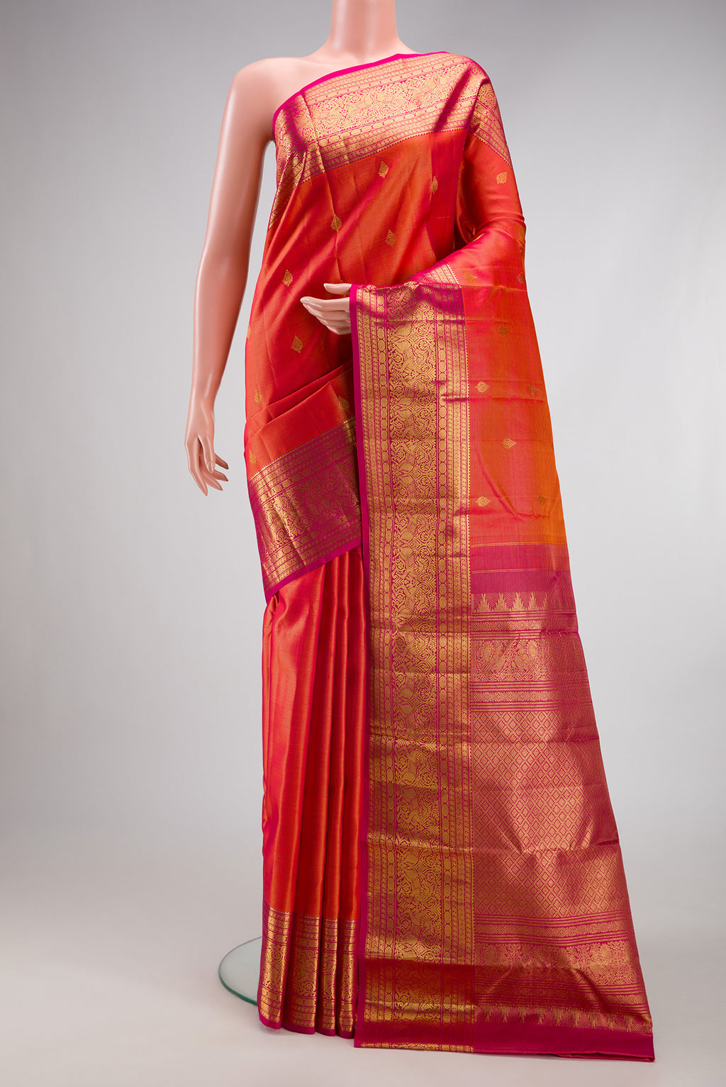 Orange Kanchipuram Silk Saree with Stripes on the body and Fancy Border.  displayed on a mannequin