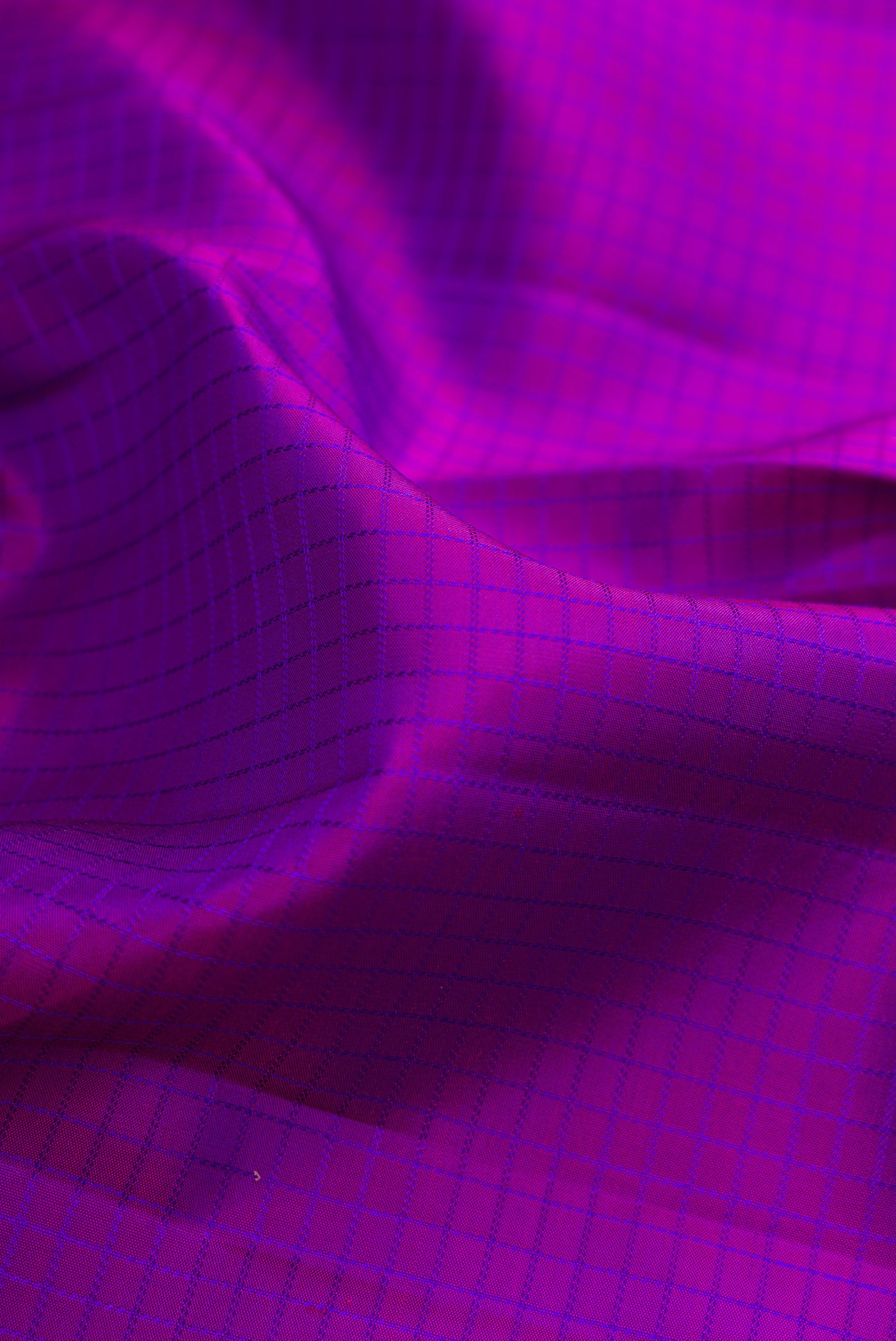 Close up of Purple Kanchipuram Silk Saree with Checked design on the body and Zari Border.  displaying folds