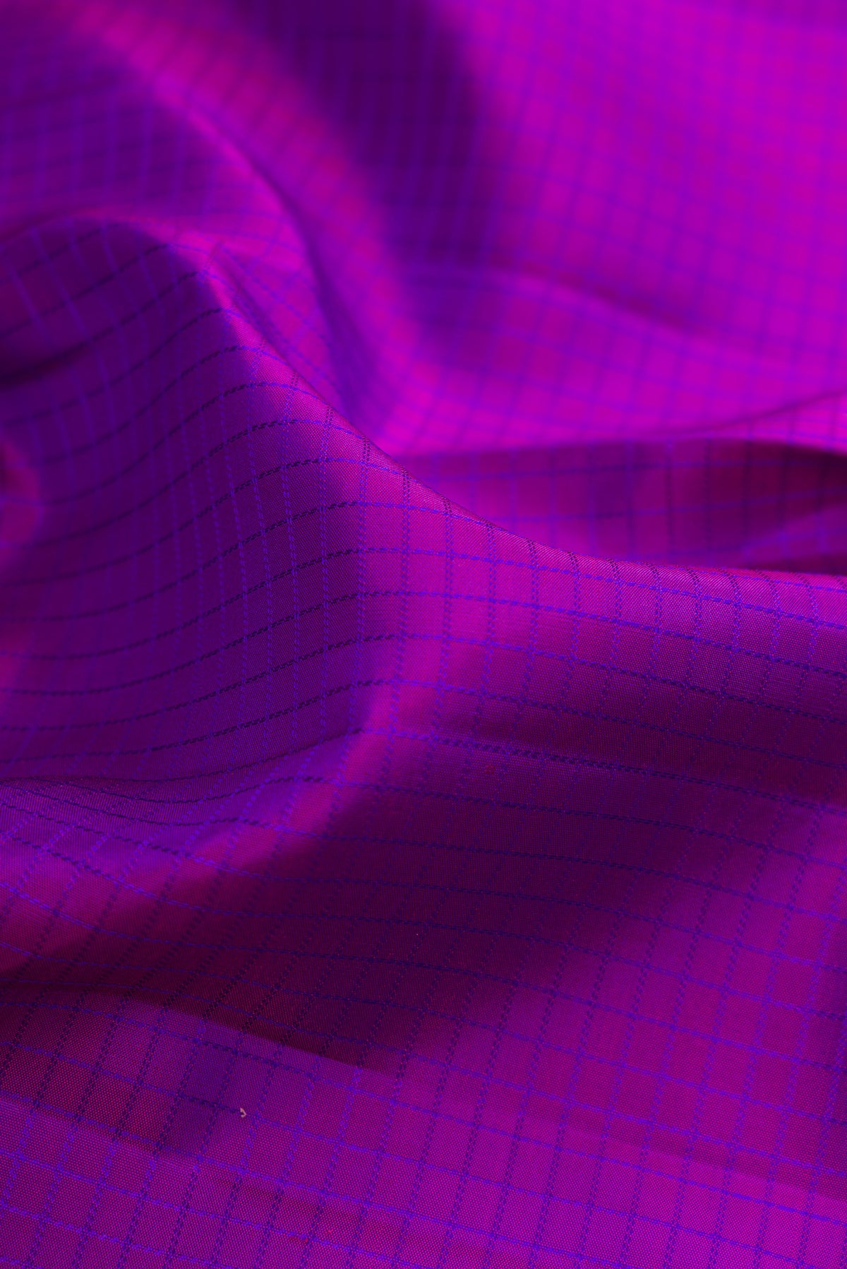 Close up of Purple Kanchipuram Silk Saree with Checked design on the body and Zari Border.  displaying folds