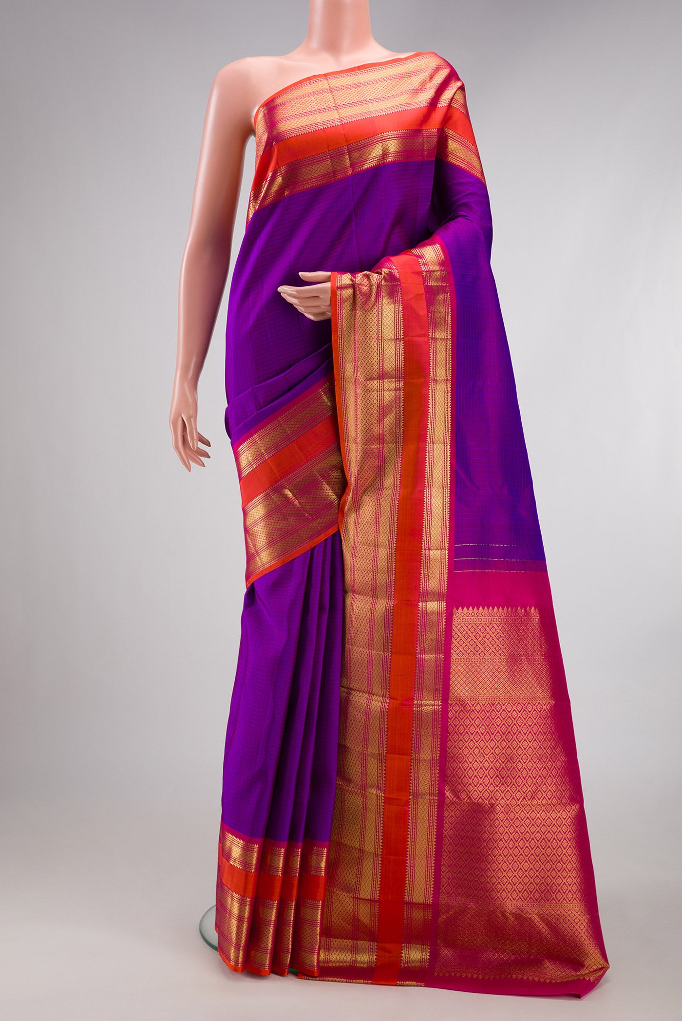 Purple Kanchipuram Silk Saree with Checked design on the body and Zari Border.  displayed on a mannequin