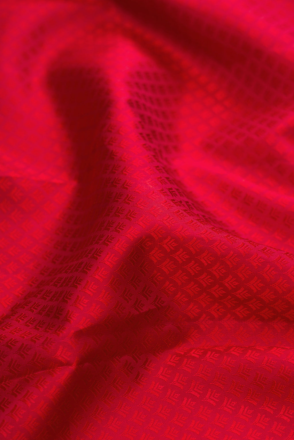 Close up of Pure Silk Maroon Kanjivaram Saree with Jacquard design on the body and Zari Border.  displaying folds