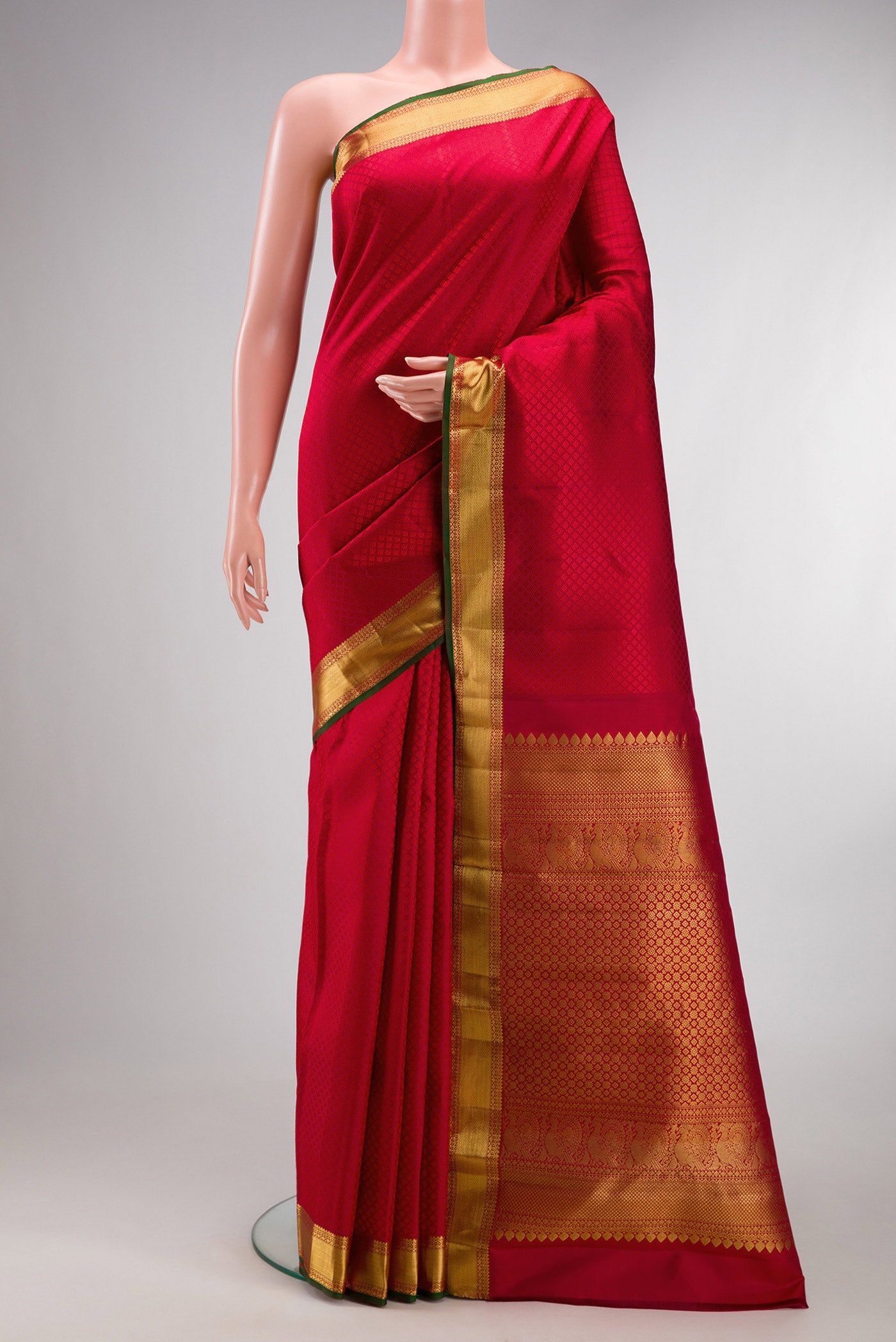Pure Silk Maroon Kanjivaram Saree with Jacquard design on the body and Zari Border.  displayed on a mannequin