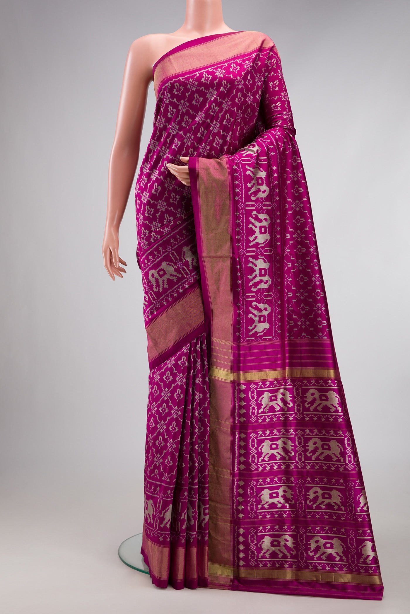Magenta Double Ikat Saree with Pure Ikat on the body and Zari Border.  displayed on a mannequin