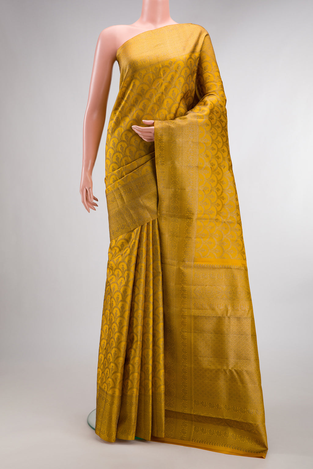 Pure Silk Mustard Kanjivaram Saree with Zari Brocade on the body and Zari Border.  displayed on a mannequin