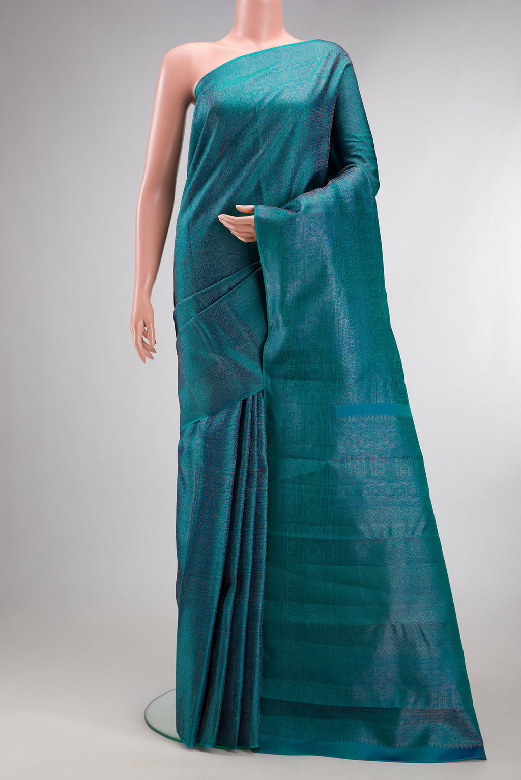 Pure Silk Peacock Blue Kanjivaram Saree with Zari Brocade on the body and Zari Border.  displayed on a mannequin