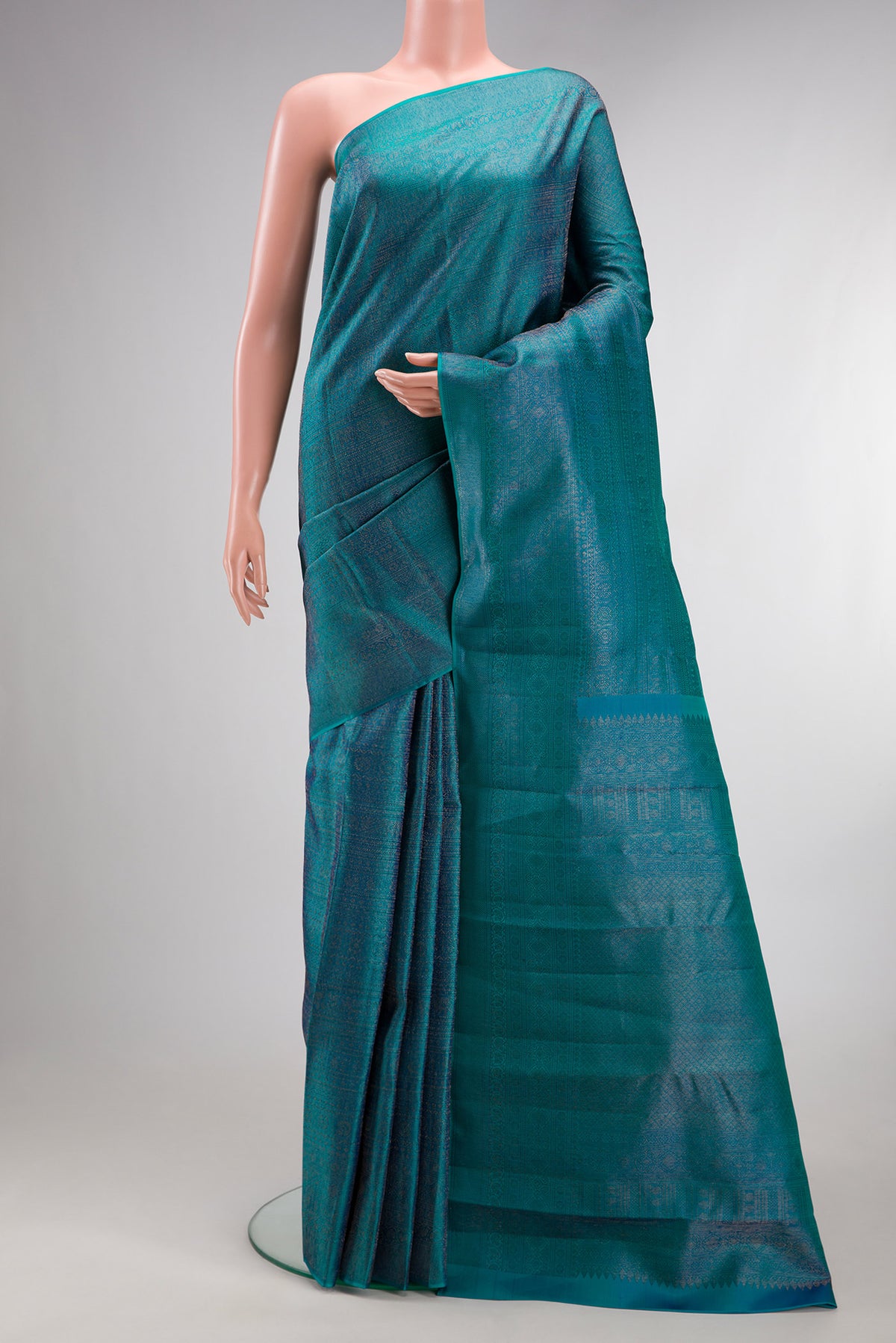 Pure Silk Peacock Blue Kanjivaram Saree with Zari Brocade on the body and Zari Border.  displayed on a mannequin