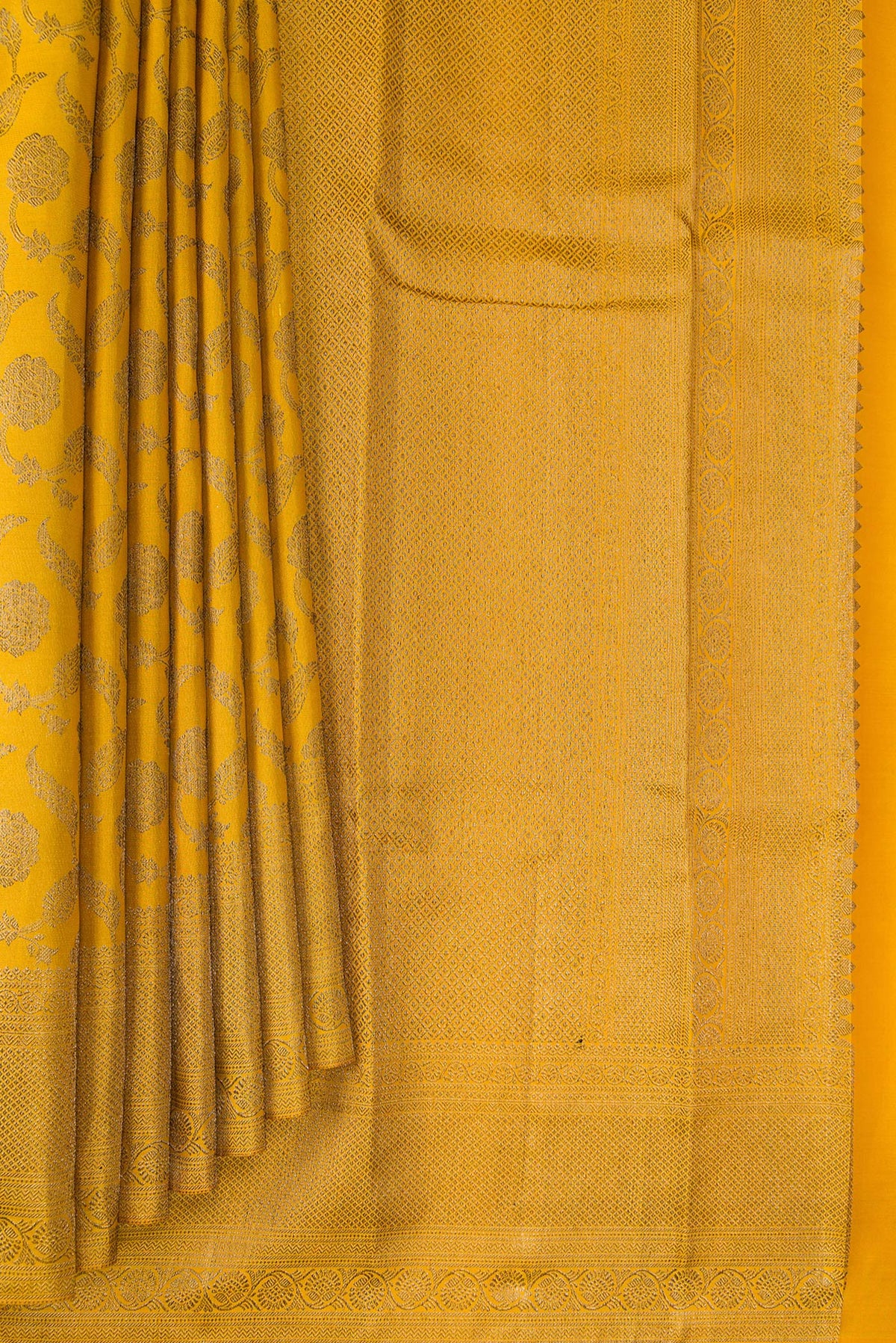 Pleats and pallu of Pure Silk Mustard Kanjivaram Saree with Zari Brocade on the body and Fancy Border. 