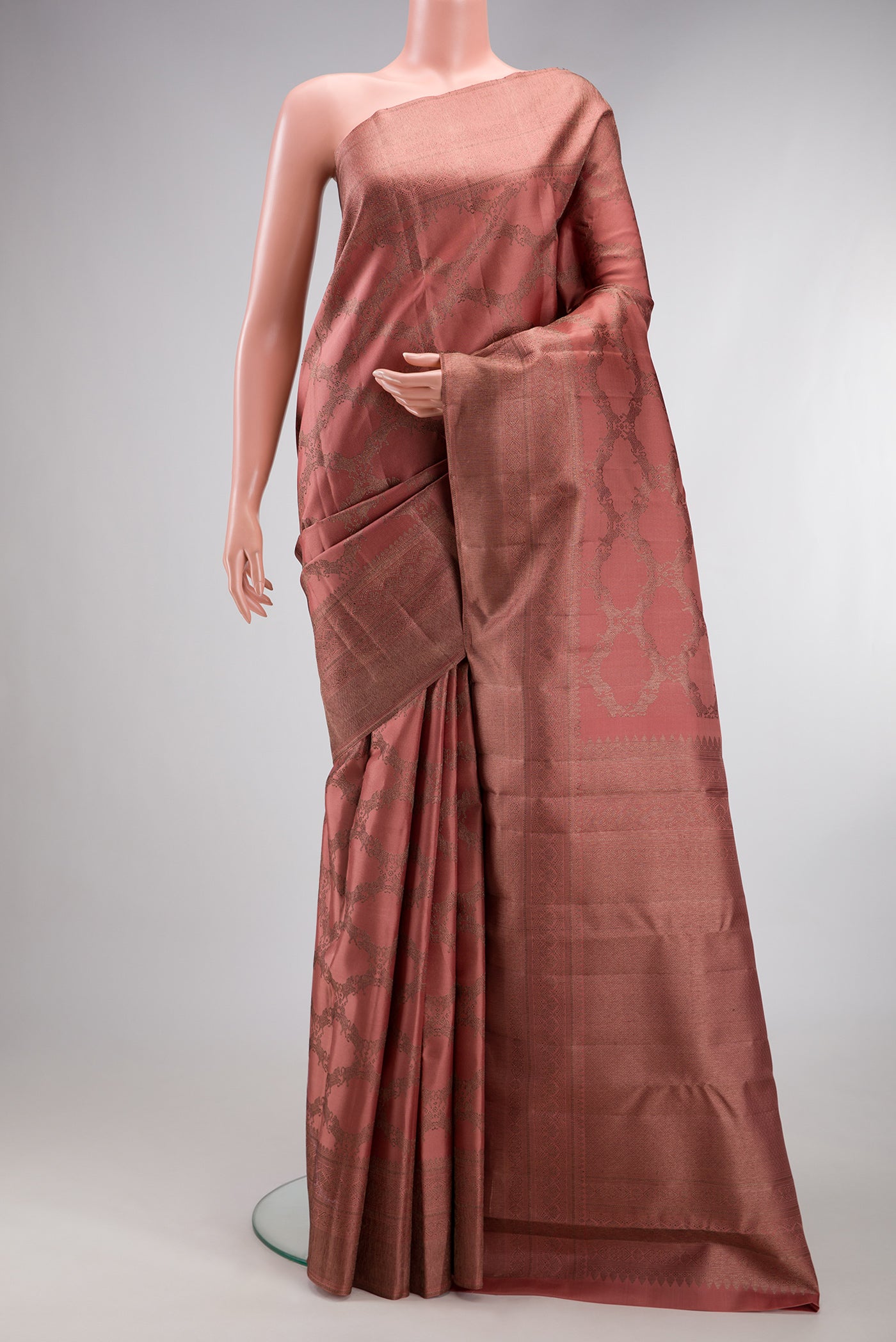 Coral Kanjivaram Silk Saree with Jacquard design on the body and Fancy Border.  displayed on a mannequin