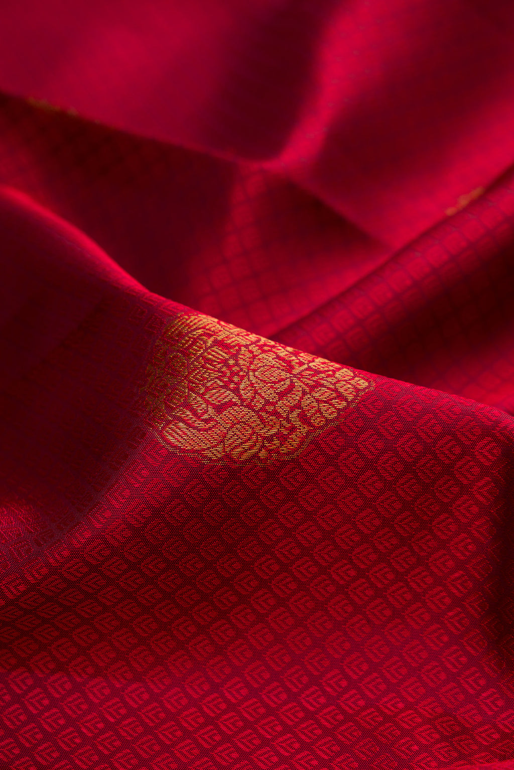 Close up of Maroon Kanjivaram Silk Saree with Jacquard With Zari Butta on the body and Zari Border.  displaying folds