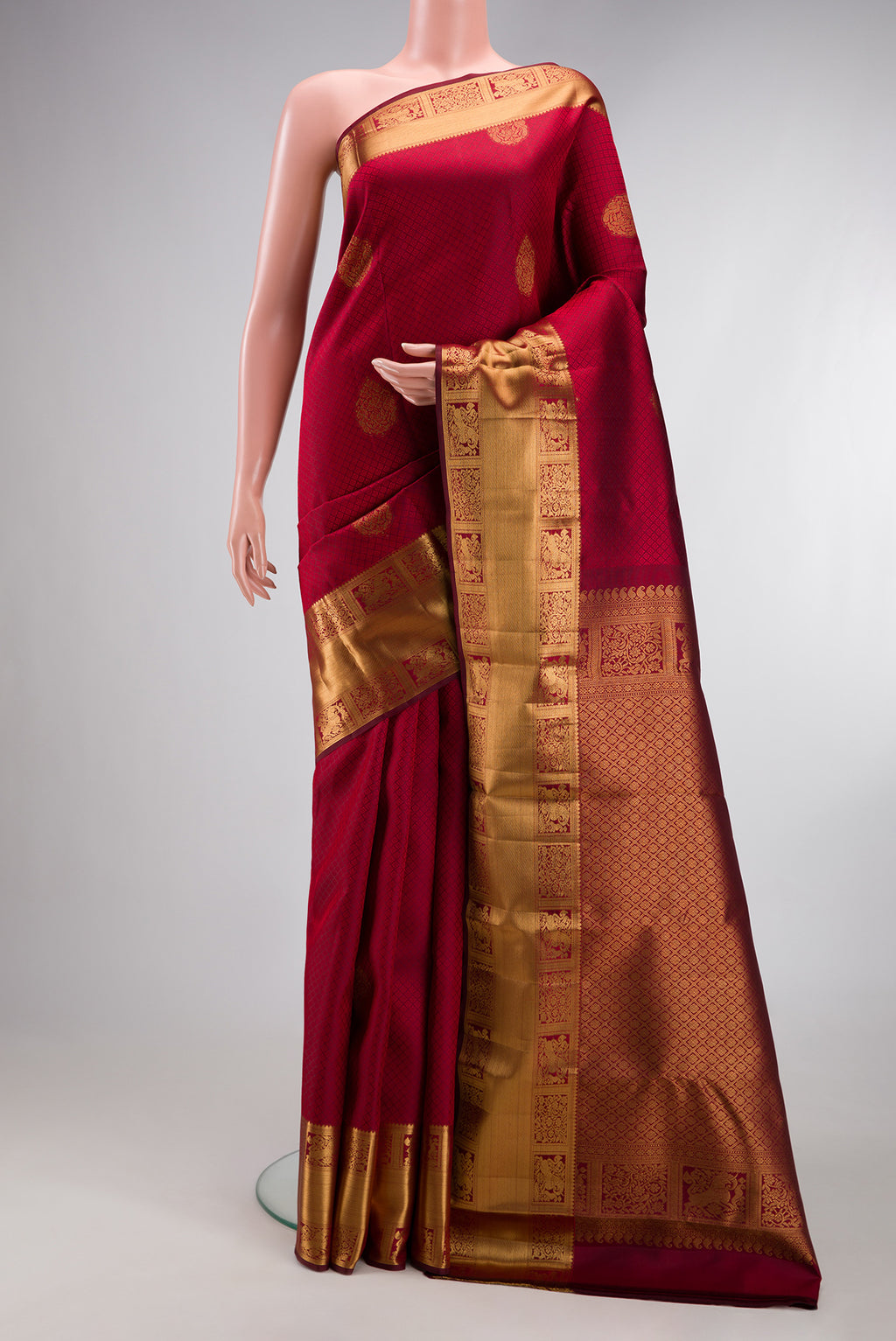 Maroon Kanjivaram Silk Saree with Jacquard With Zari Butta on the body and Zari Border.  displayed on a mannequin
