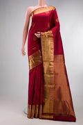 Maroon Kanjivaram Silk Saree with Jacquard With Zari Butta on the body and Zari Border.  displayed on a mannequin