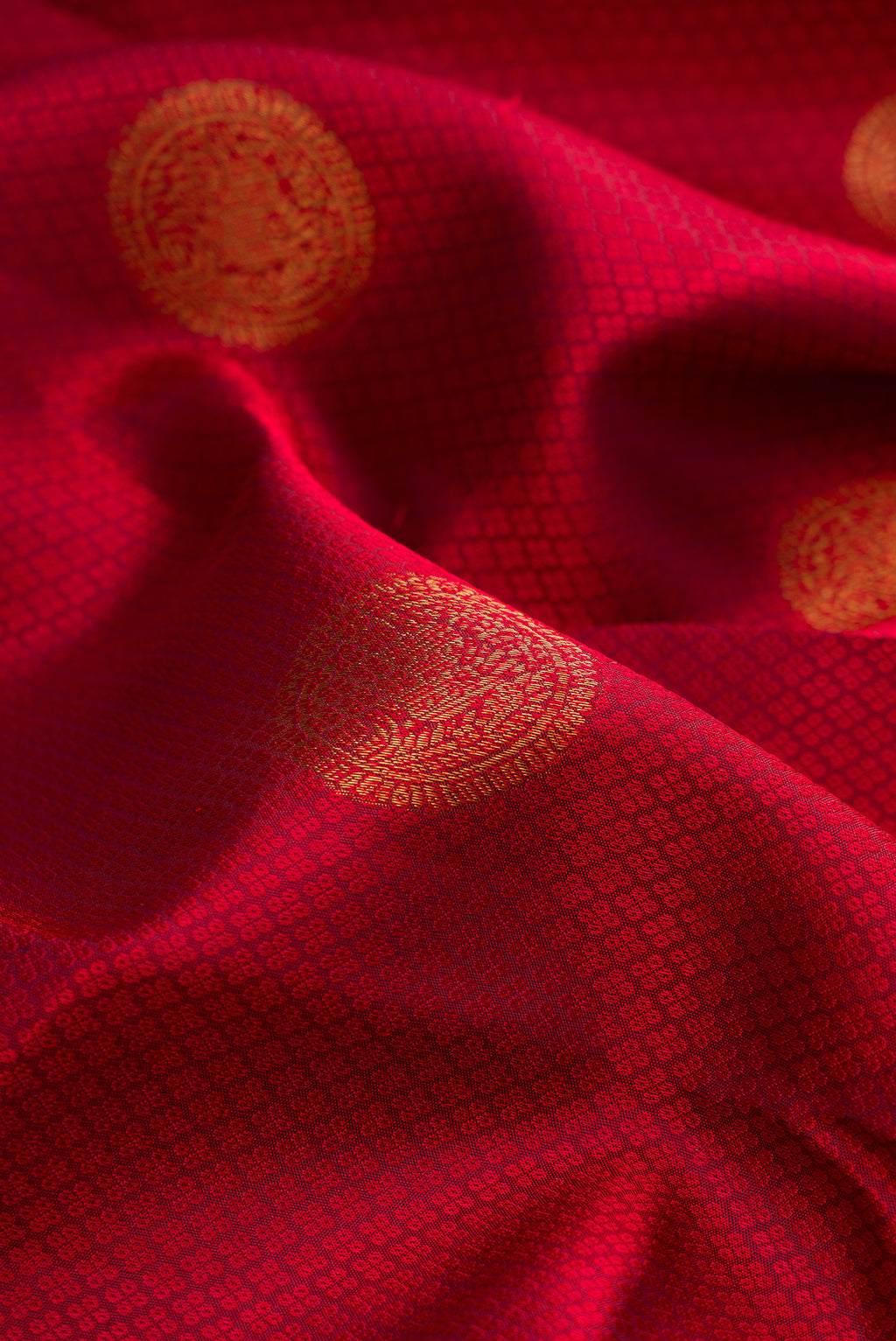 Close up of Maroon Kanjivaram Silk Saree with Jacquard With Zari Butta on the body and Zari Border.  displaying folds
