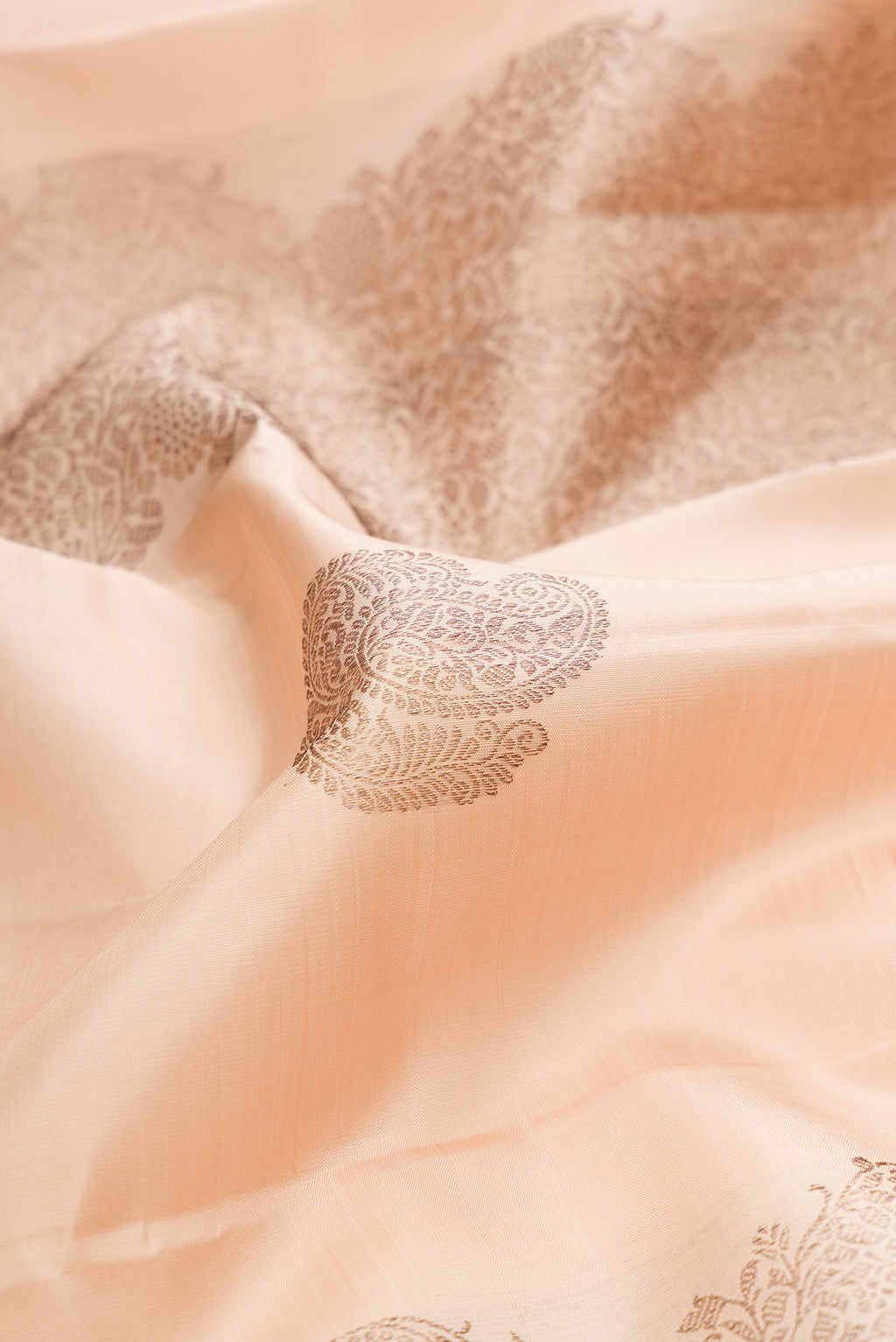 Close up of Sandal Kanjivaram Silk Saree with Zari Butta on the body and Without Border.  displaying folds