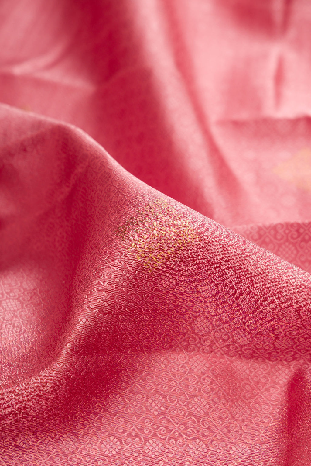 Close up of Rose pink Kanjivaram Silk Saree with Jacquard design on the body and Fancy Border.  displaying folds