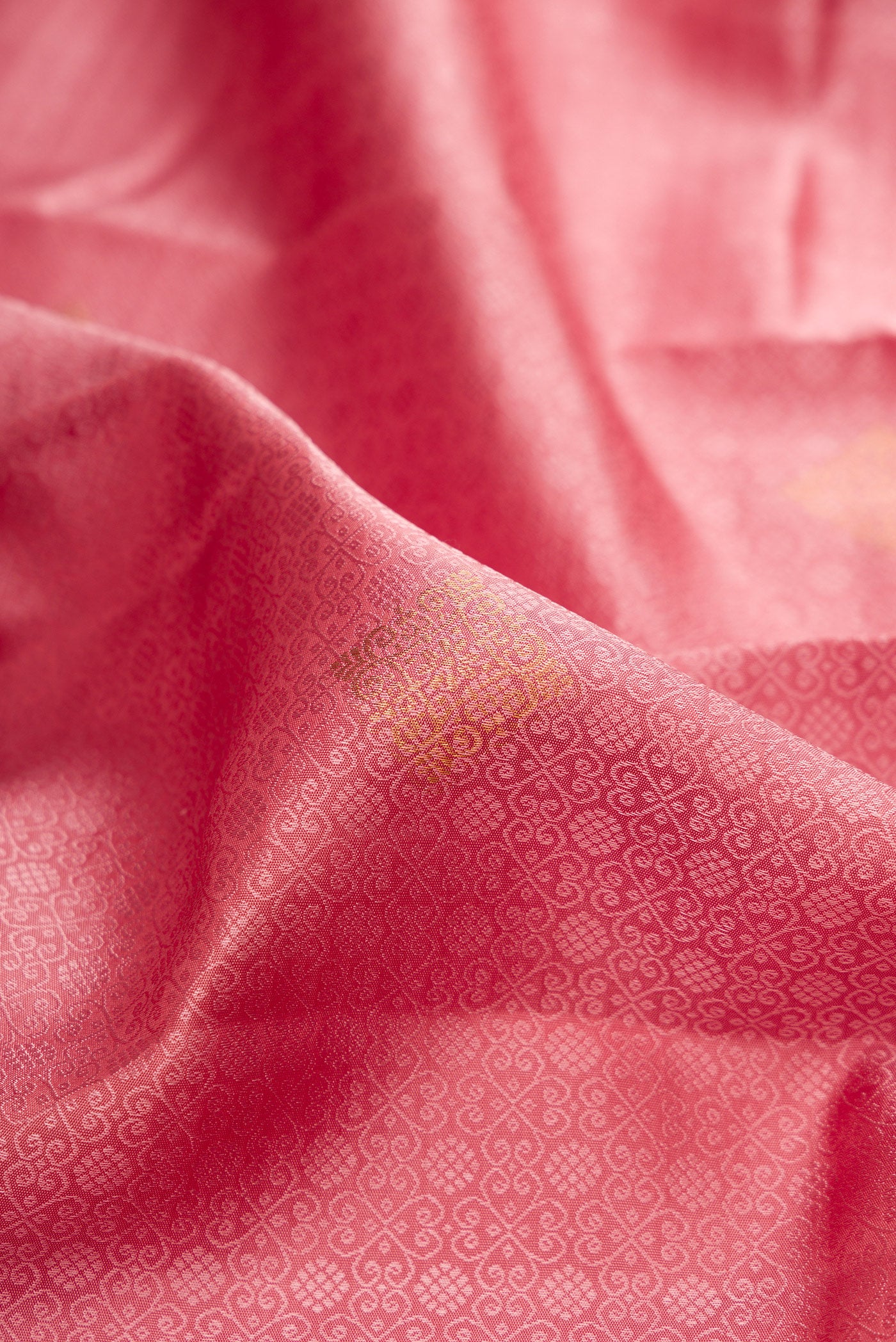 Close up of Rose pink Kanjivaram Silk Saree with Jacquard design on the body and Fancy Border.  displaying folds