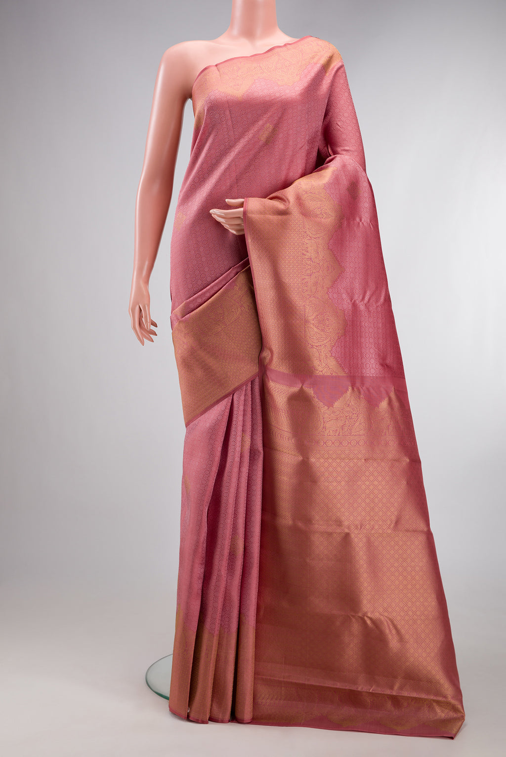 Rose pink Kanjivaram Silk Saree with Jacquard design on the body and Fancy Border.  displayed on a mannequin