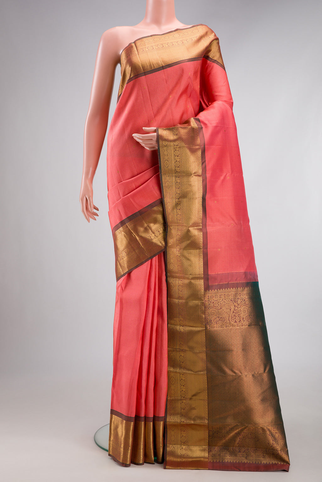 Coral Kanjivaram Silk Saree with Stripes on the body and Zari Border.  displayed on a mannequin