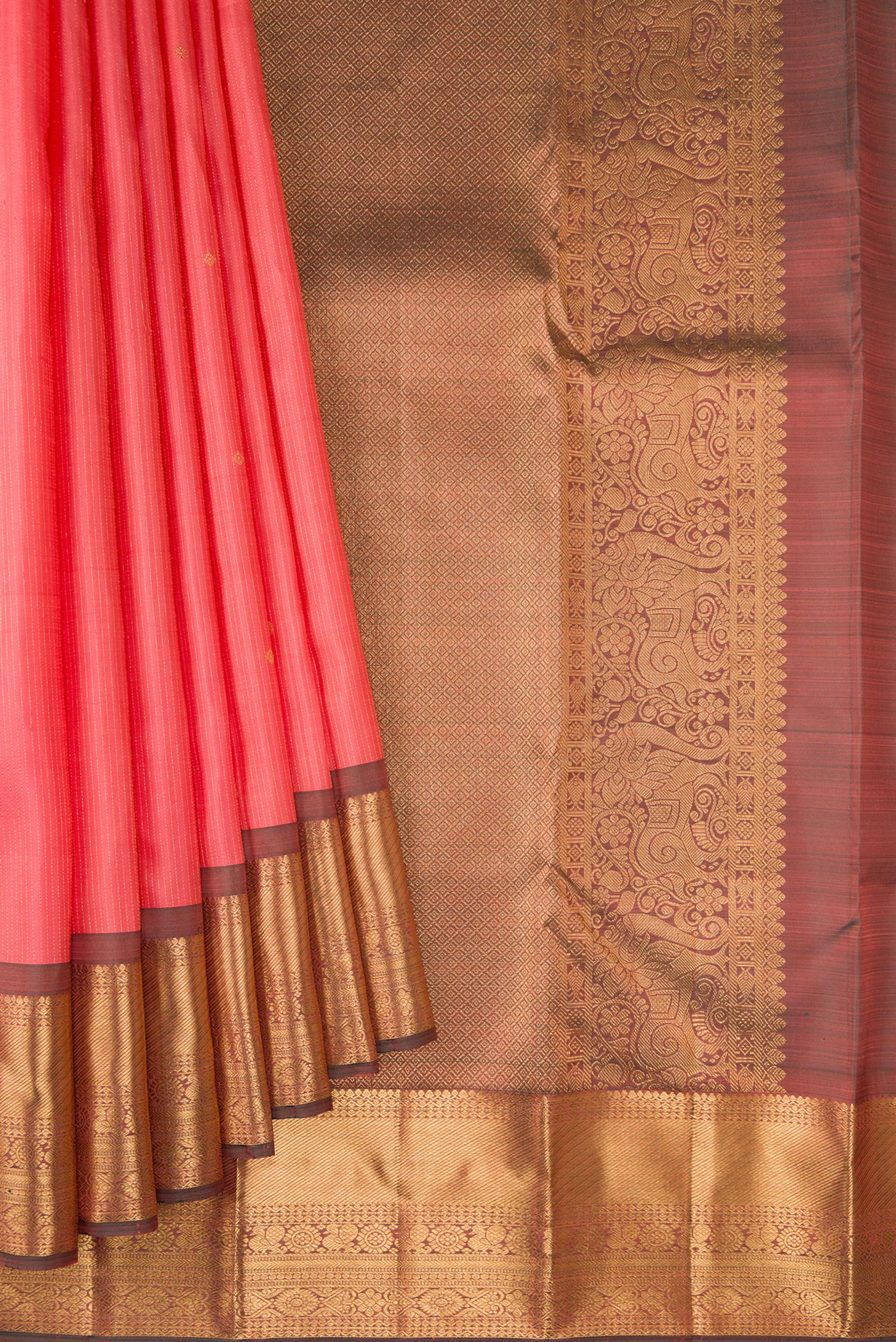 Pleats and pallu of Coral Kanjivaram Silk Saree with Stripes on the body and Zari Border. 