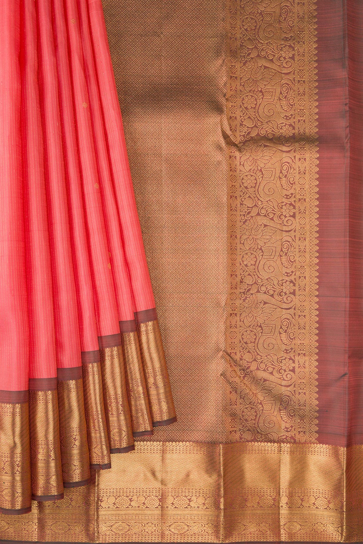 Pleats and pallu of Coral Kanjivaram Silk Saree with Stripes on the body and Zari Border. 