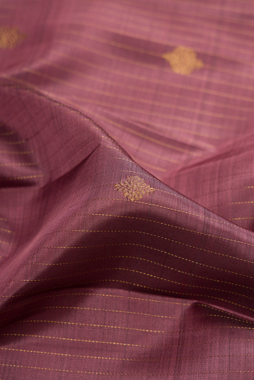Close up of Pink Dual Tone Kanjivaram Silk Saree with Stripes on the body and Zari Border.  displaying folds