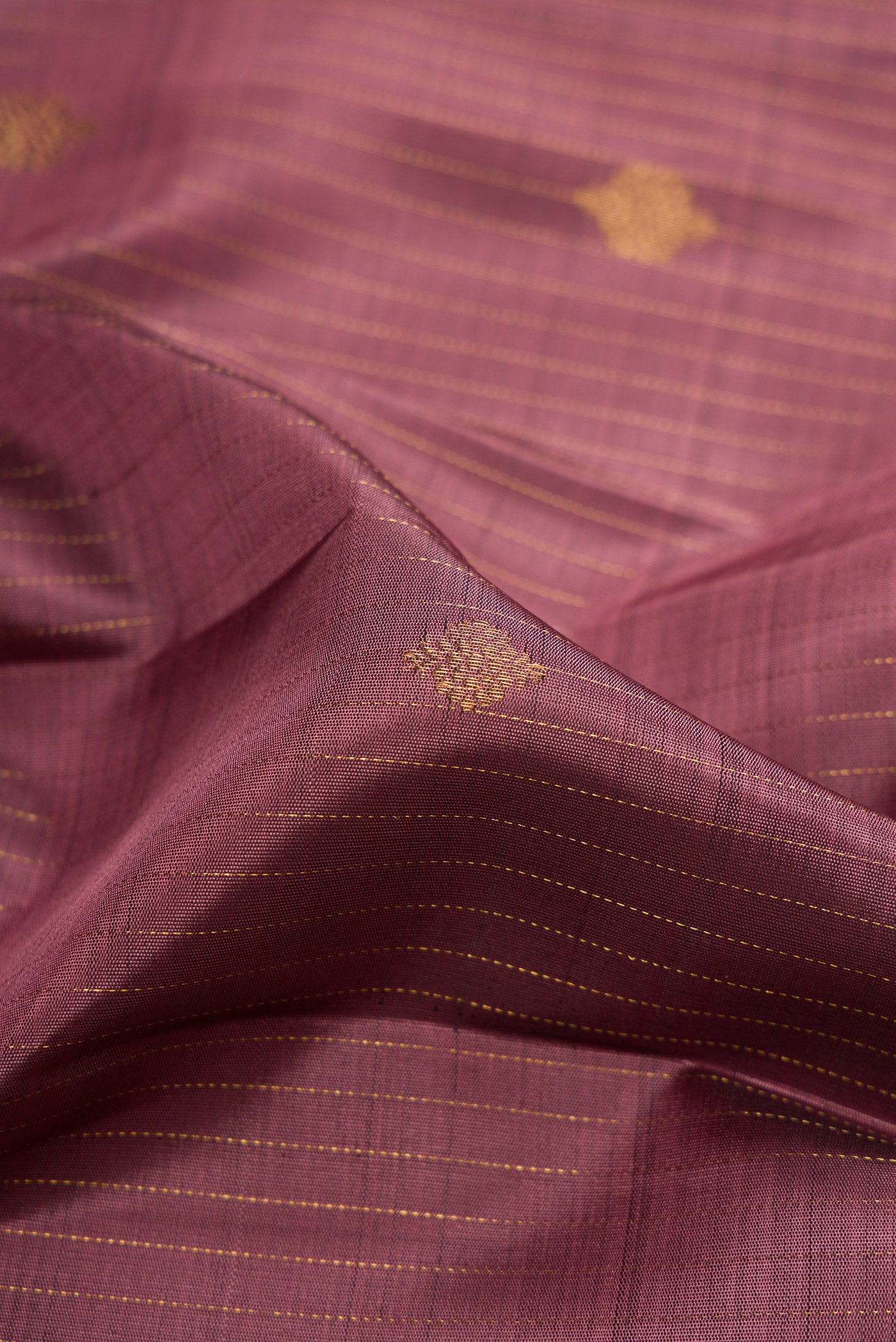 Close up of Pink Dual Tone Kanjivaram Silk Saree with Stripes on the body and Zari Border.  displaying folds