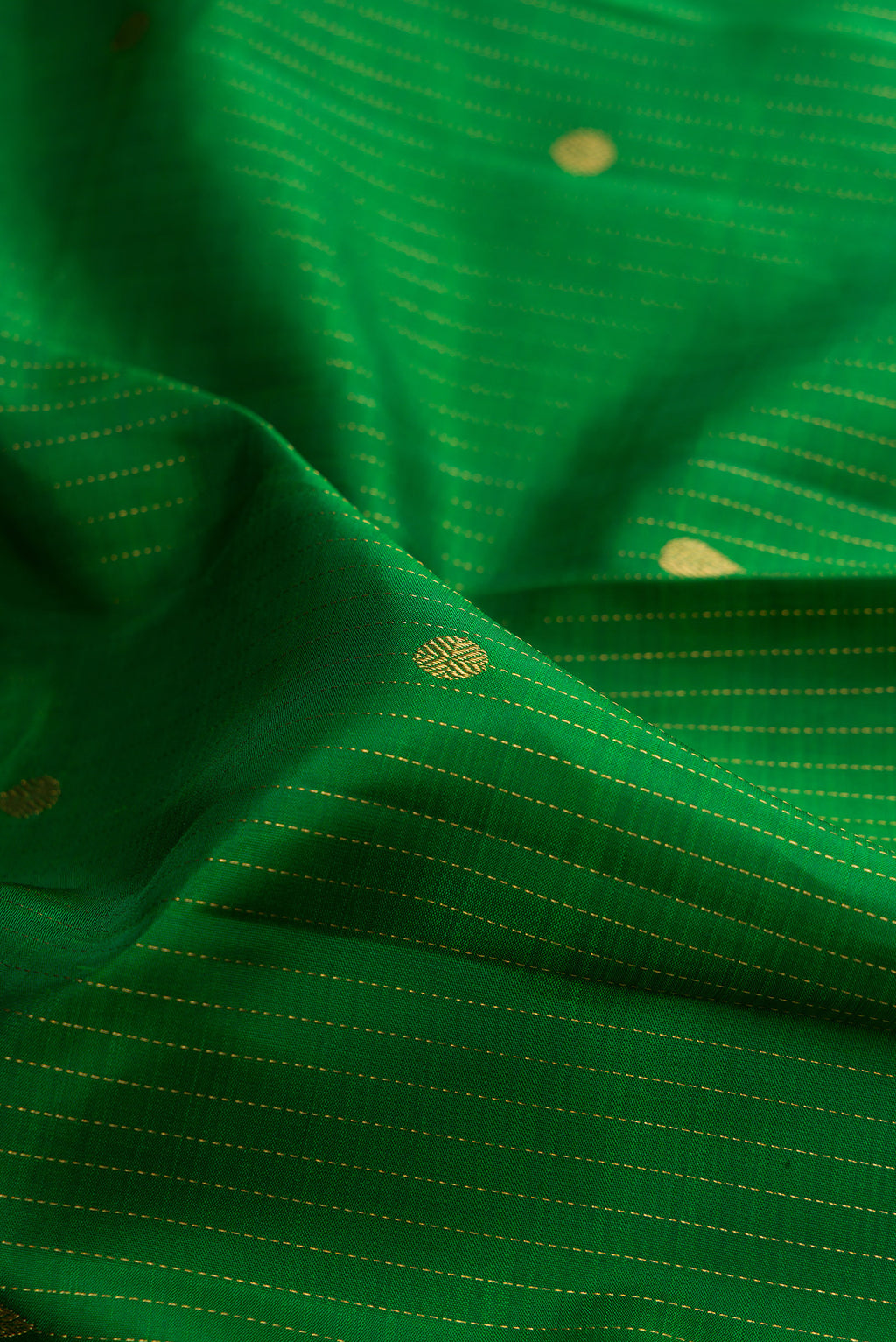 Close up of Pure Silk Green Kanjivaram Saree with Checked design on the body and Zari Border.  displaying folds