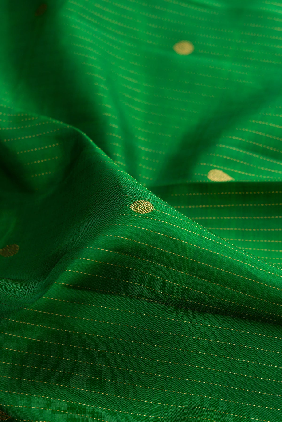 Close up of Pure Silk Green Kanjivaram Saree with Checked design on the body and Zari Border.  displaying folds
