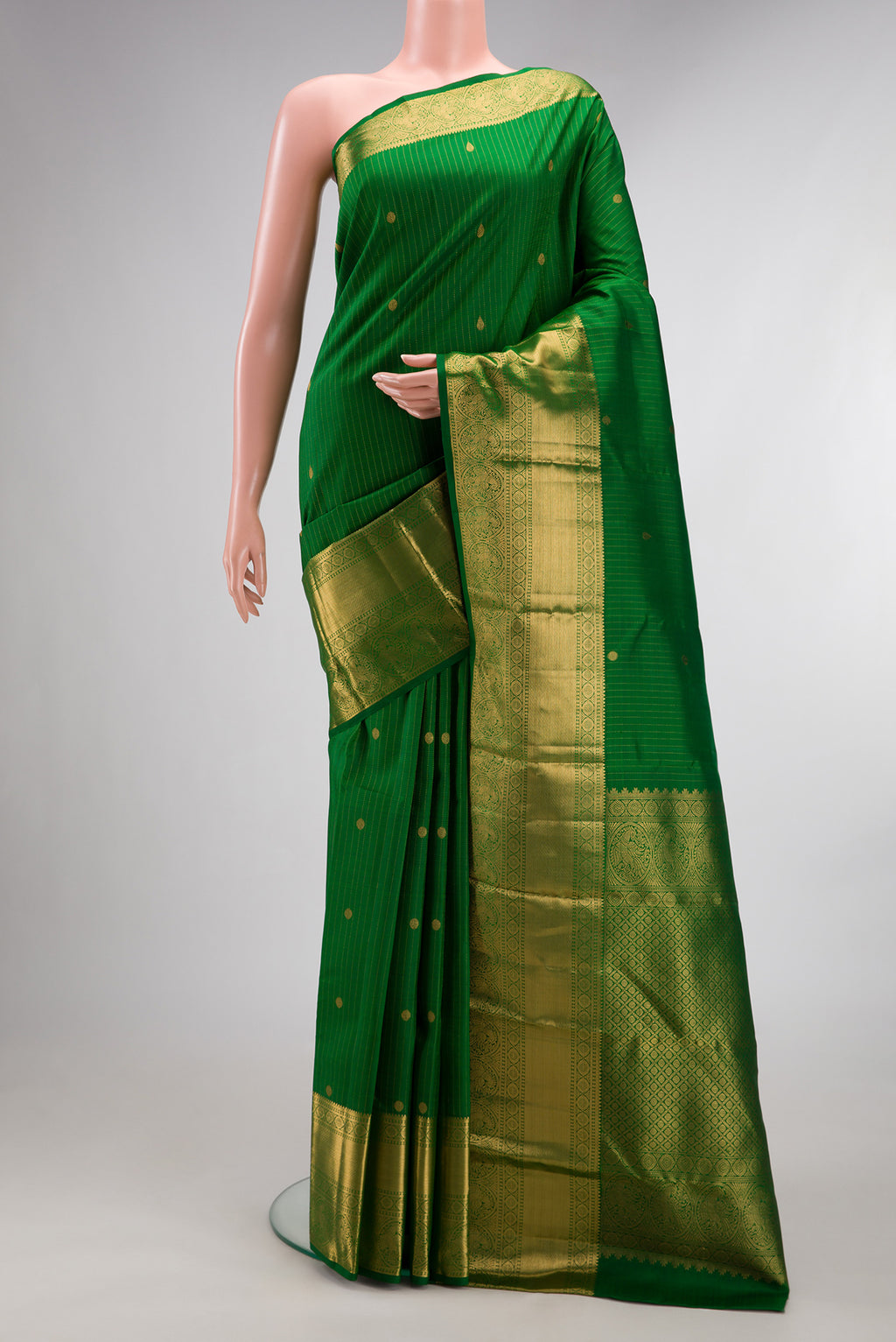 Pure Silk Green Kanjivaram Saree with Checked design on the body and Zari Border.  displayed on a mannequin